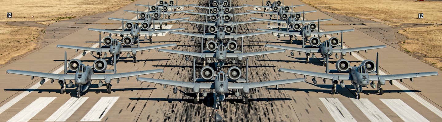 U.S. Air Force A-10Cs, an HH-60G Pave Hawk and an HC-130J Combat King II assigned to the 355th Wing taxi in formation on the runway at Davis-Monthan Air Force Base, Arizona, February 9, 2022. <em>U.S. Air Force photo by Senior Airman Alex Miller</em>