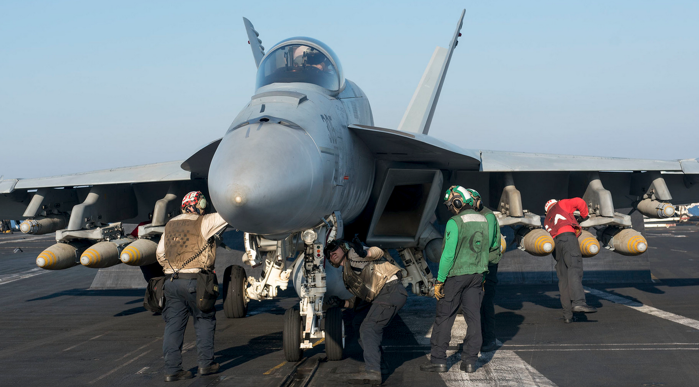 A very heavily-laden F/A-18E is prepped for a mission over Syria. (U.S. Navy photo by Mass Communication Specialist 3rd Class Matt Matlage)