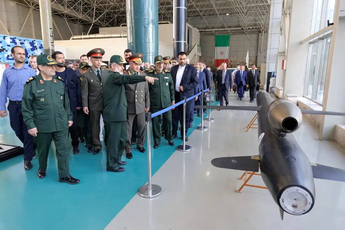 Russian Defense Minister Sergei Shoigu is shown an Iranian land attack cruise missile design during his visit to the IRGC  exhibition. <em>Russian Defense Ministry</em>