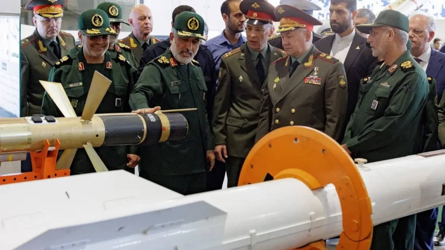 Russia's Defense Minister Sergei Shoigu, in the front row, second from the right, is shown a 358 missile at an Islamic Revolutionary Guard Corps (IRGC) exhibition in Iran.<em> Russian Ministry of Defense</em>