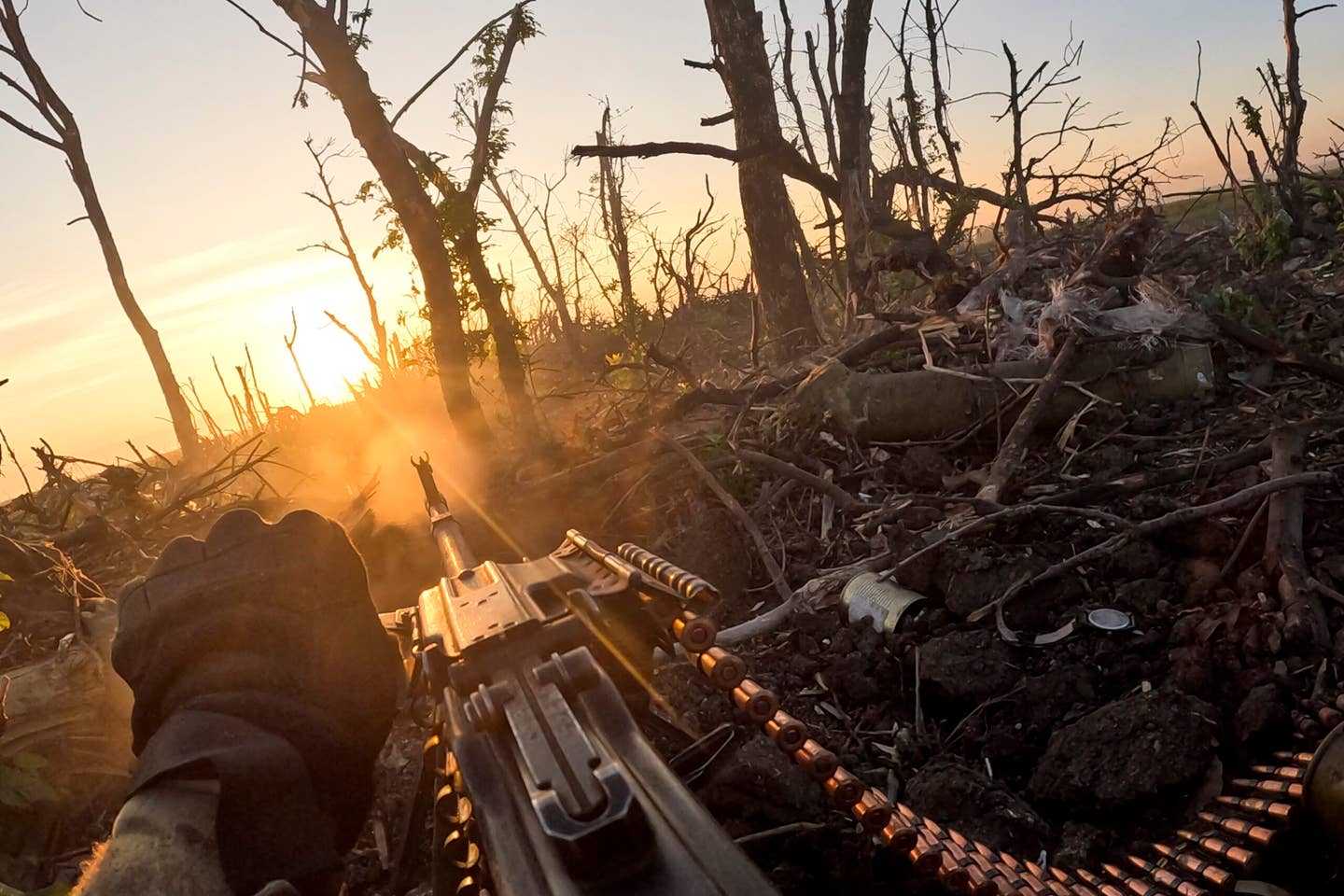In this image taken from a video released by the 3rd Assault Brigade, a Ukrainian servicemen fires machine gun towards Russian positions near Andriivka, Donetsk region, Ukraine, Aug. 27, 2023. Ukrainian brigade's two-month battle to fight its way through a charred forest shows the challenges of the country's counteroffensive in the east and south. (AP Photo)