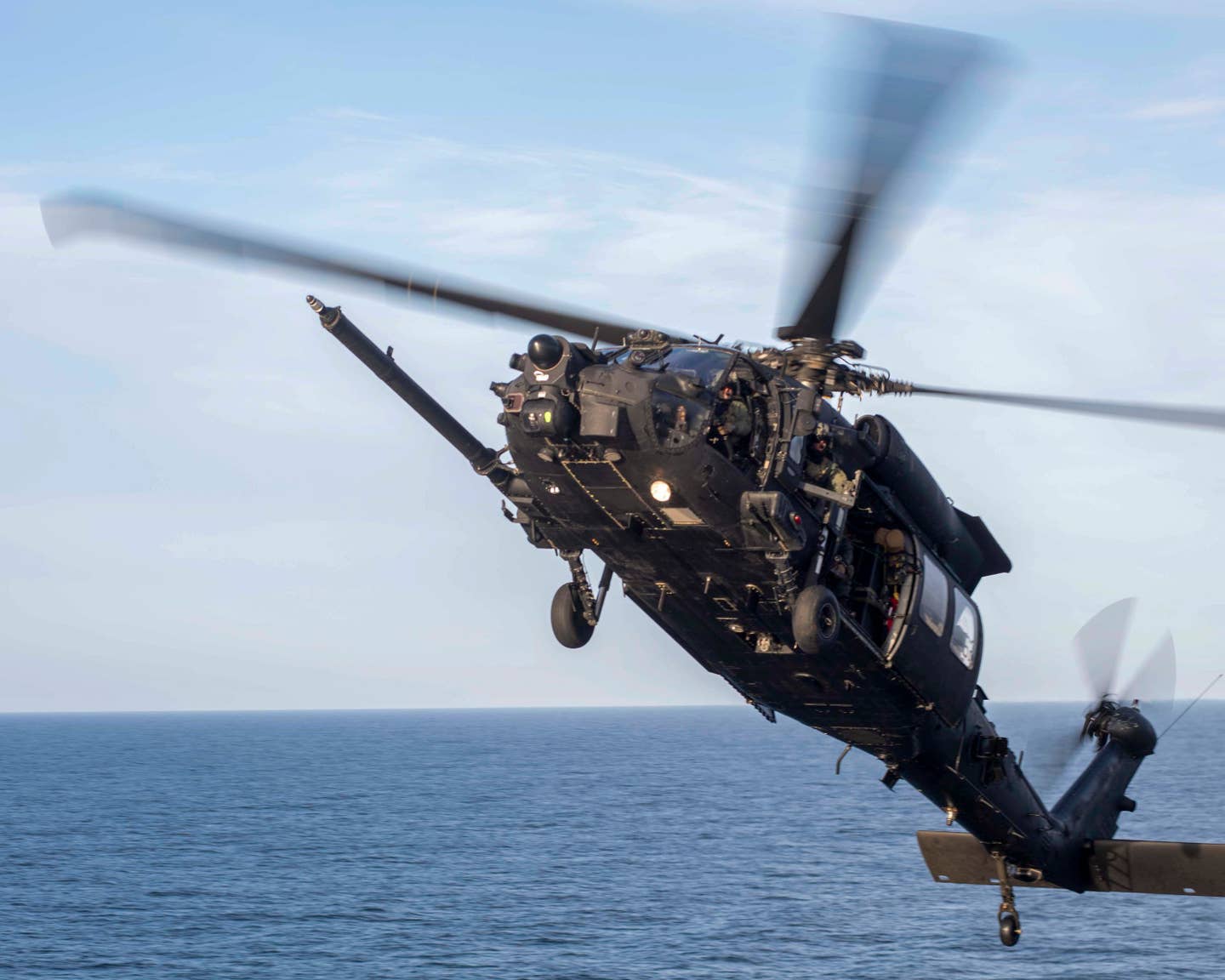 Dispensers capable of launching decoy flares and chaff can be seen on the tail boom in this picture of one of the 160th SOAR's MH-60Ms taking part in Polar Dagger. <em>USN</em>