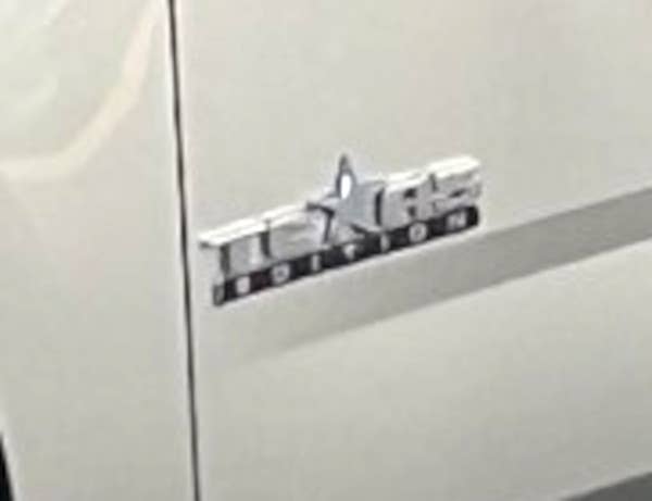 A close-up look at the distinctive Texas Edition badge on the driver's door on the stretched Chevy Suburban command vehicle. <em>Accelerated Media Technologies</em>