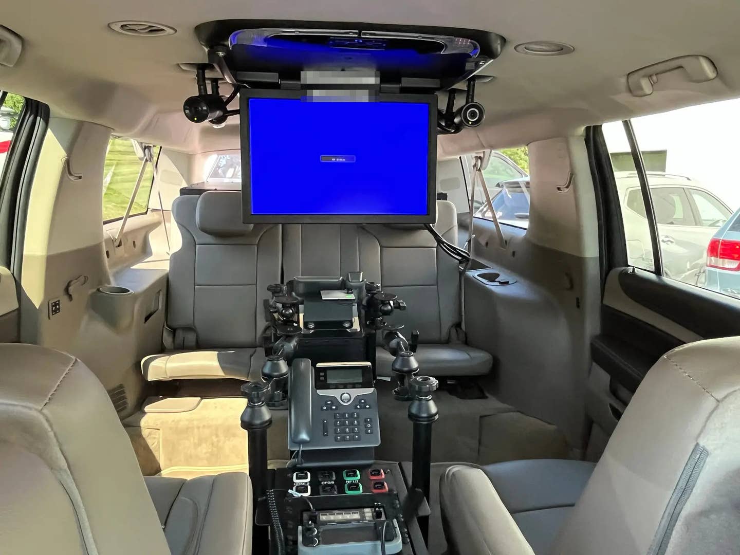A view of the main passenger cabin inside the stretched Suburban command vehicle. What appears to be an equipment box at the very rear is also just visible over the back of the rear seats. <em>Accelerated Media Technologies</em>