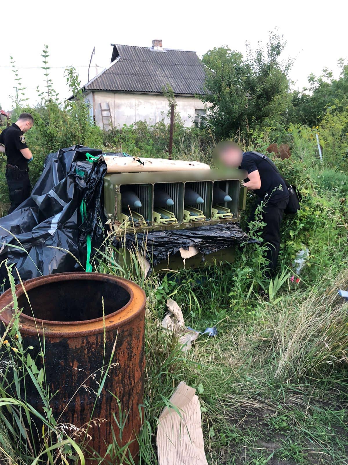 Ukrainian National Police investigate Tor air defense missiles they discovered. (Ukrainian National Police photo)