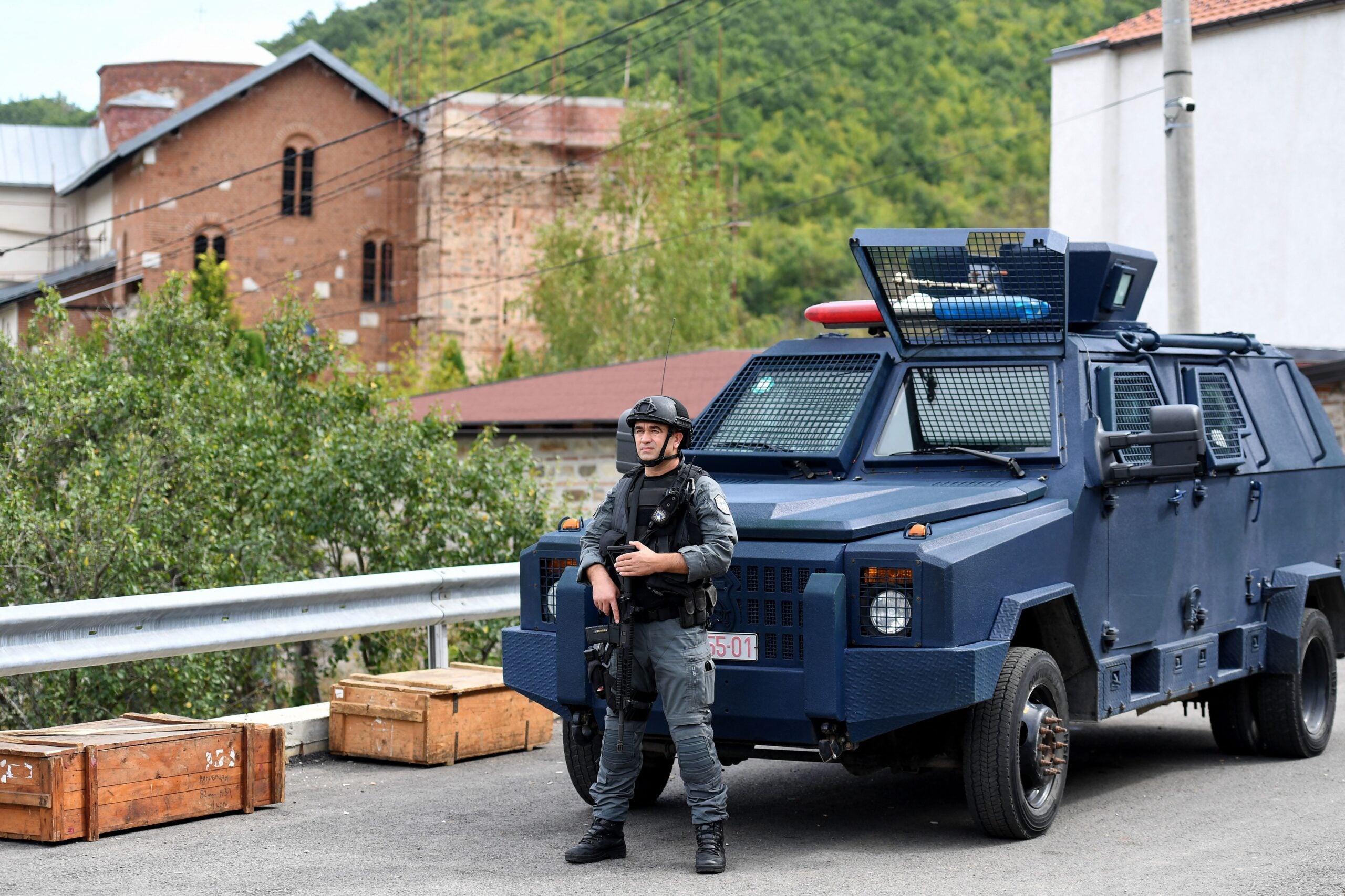 A member of a Kosovo police special unit stands guard in an area around the Banjska Monastery in Banjska, north Kosovo, some 15km from the border with Serbia, on September 27, 2023. A Kosovo court on September 26 remanded two suspected gunmen into custody after they were arrested at the weekend during a firefight and standoff with police near the border with Serbia. The court's decision came days after the killing of a police officer during an ambush and an ensuing gunbattle at a monastery in the village of Banjska, marking one of the gravest escalations in Kosovo for years. (Photo by STRINGER / AFP) (Photo by STRINGER/AFP via Getty Images)