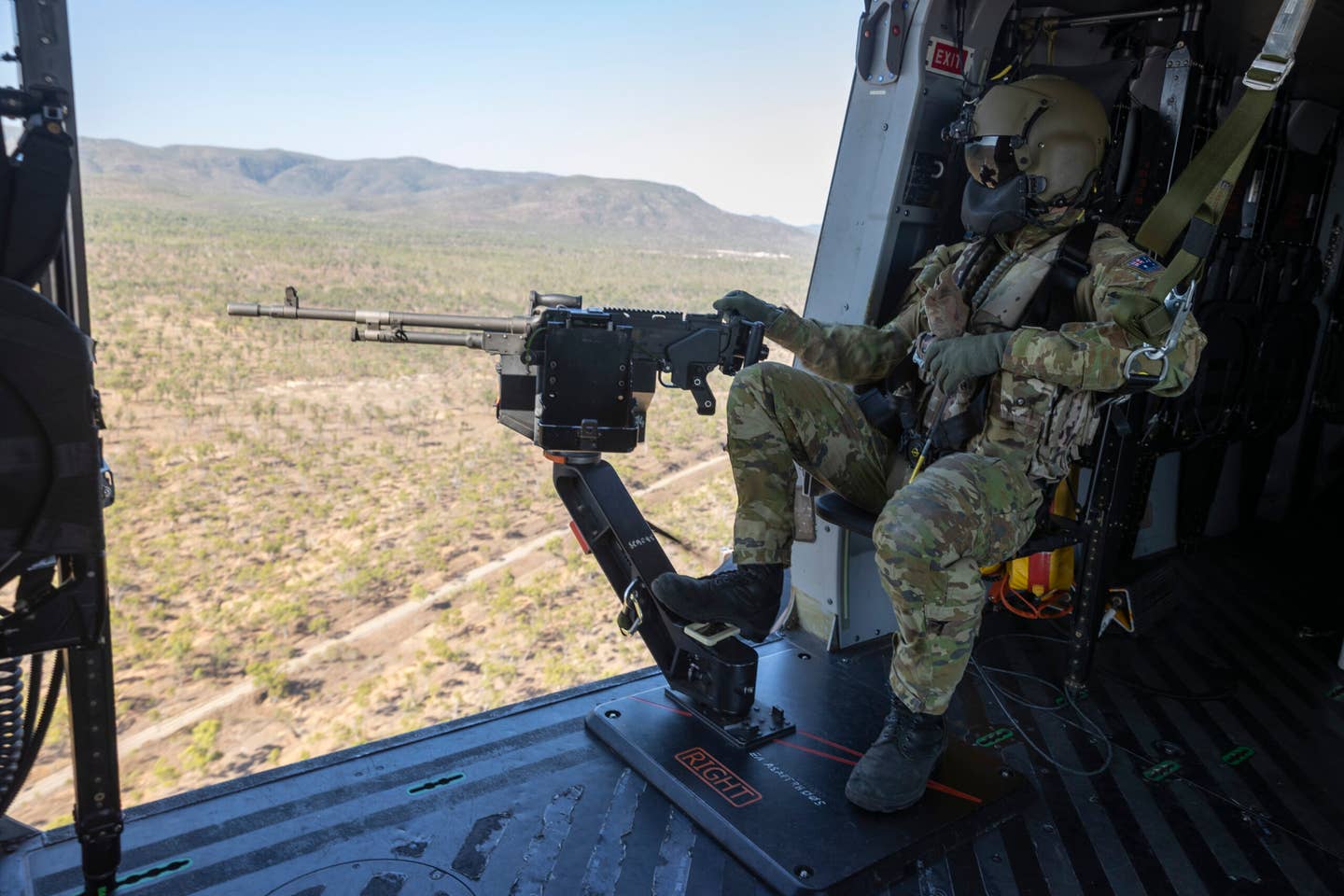 An Australian Army soldier from the 5th Aviation Regiment mans the door gun on an MRH90 during Exercise Vigilant Scimitar, Townsville Field Training Area, November 2020. <em>COMMONWEALTH OF AUSTRALIA, DEPARTMENT OF DEFENSE</em>