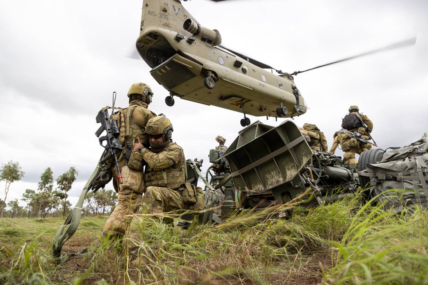 Australian Army soldiers from the 4th Regiment, Royal Australian Artillery, prepare an M777 howitzer to be transported by a CH-47F Chinook from the 5th Aviation Regiment in Townsville Field Training Area, Queensland, in May 2022. <em>COMMONWEALTH OF AUSTRALIA, DEPARTMENT OF DEFENSE</em>