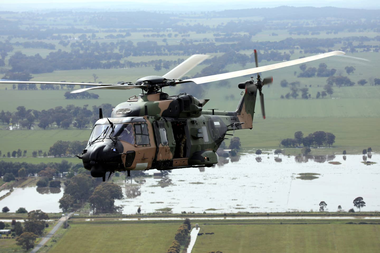 An Australian Army MRH90 Taipan helicopter from the 6th Aviation Regiment conducts reconnaissance at Shepparton, Victoria, as part of Operation Flood Assist 2022. Australian Army personnel from the 6th Aviation Regiment helped provide assistance to flood-affected communities in Victoria and New South Wales. <em>COMMONWEALTH OF AUSTRALIA, DEPARTMENT OF DEFENSE</em>