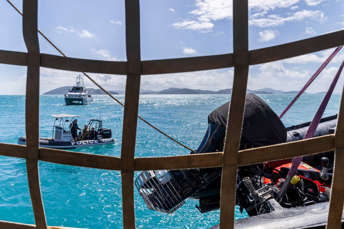 Royal Australian Navy clearance divers and Queensland Water Police return to the auxiliary ship ADV <em>Reliant</em> after conducting diving operations during the MRH90 Taipan recovery operation. <em>COMMONWEALTH OF AUSTRALIA, DEPARTMENT OF DEFENSE</em>