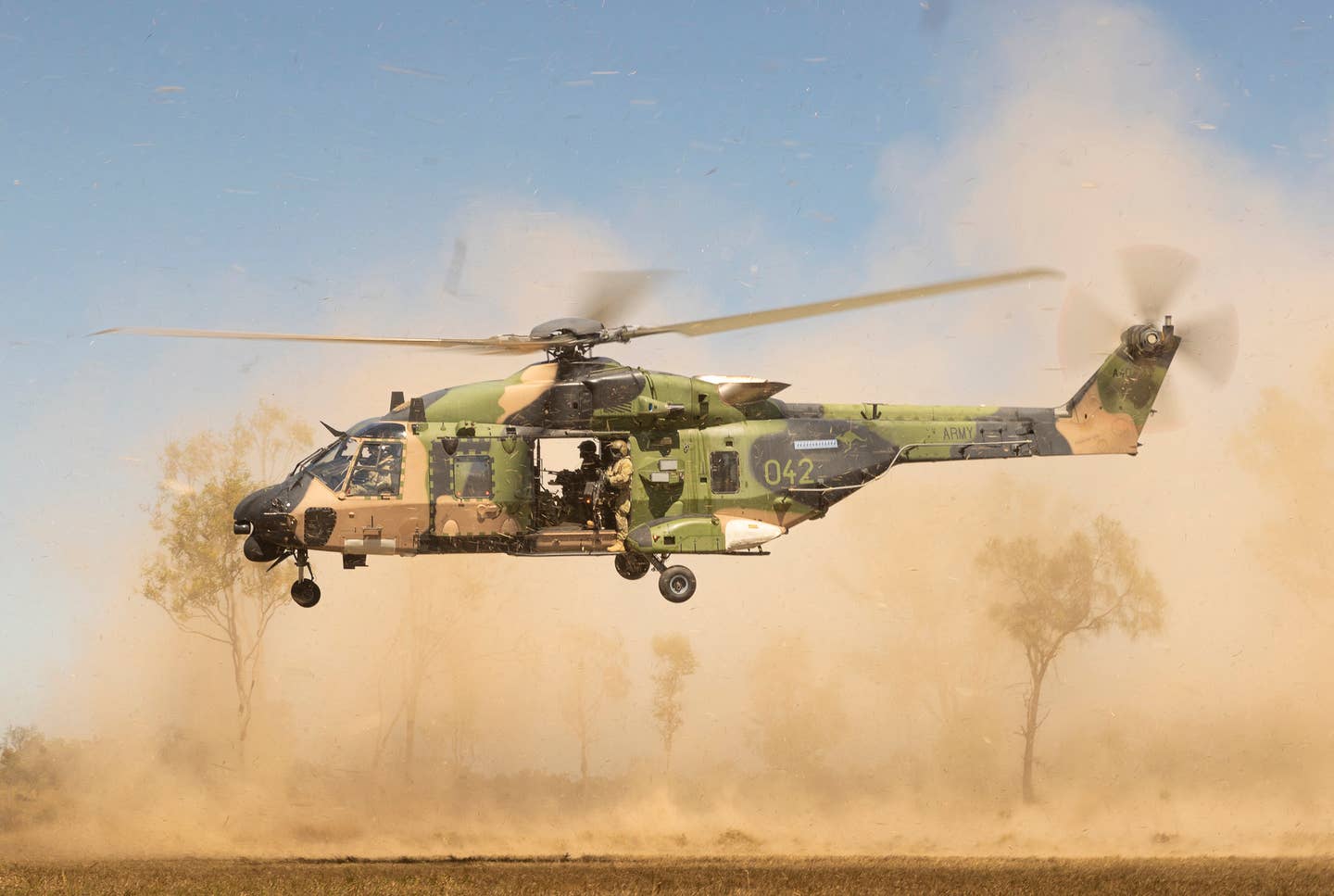 An Australian Army MRH90 Taipan from the 5th Aviation Regiment lands as part of air mobility operations with the 3rd Battalion, The Royal Australian Regiment on Exercise Brolga Run 23 at Townsville Field Training Area, Townsville, Queensland. <em>COMMONWEALTH OF AUSTRALIA, DEPARTMENT OF DEFENSE</em>