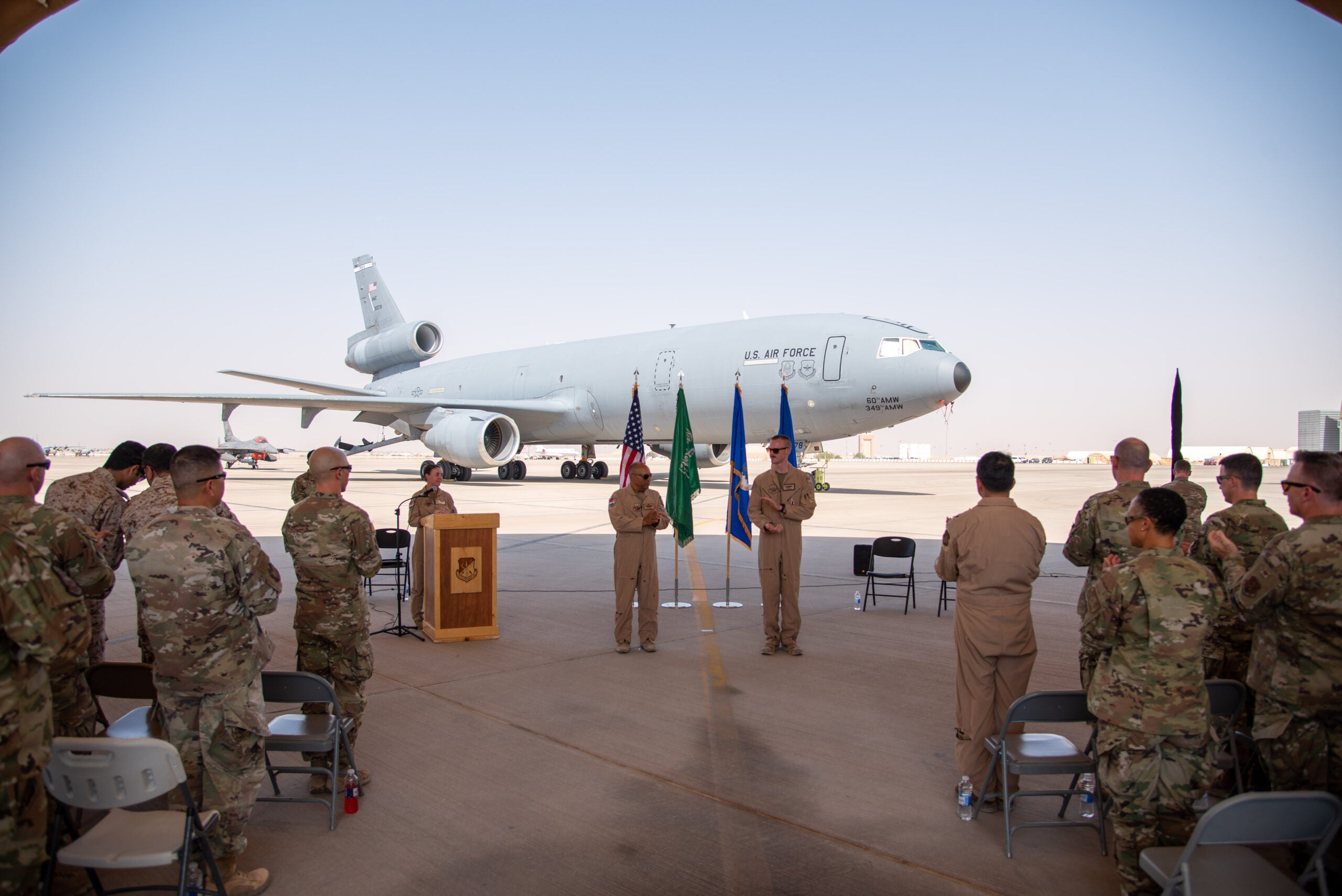 U.S. Airmen from the 378th Air Expeditionary Wing celebrate after an inactivation ceremony for the 908th Expeditionary Air Refueling Squadron at Prince Sultan Air Base, Kingdom of Saudi Arabia, Oct. 4, 2023. The ceremony highlighted the legacy of the KC-10 after over 30 years of service within the U.S. Air Forces Central (AFCENT) Area of Responsibility. By September 2024, the U.S. Air Force's fleet of KC-10s will be decommissioned and gradually replaced by the KC-46 aircraft. (U.S. Air Force photo by Tech. Sgt. Alexander Frank)