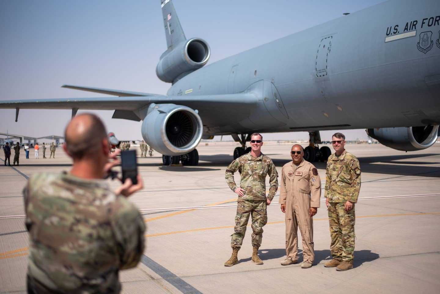 U.S. Air Force Col. Clinton Varty (left), 60th Maintenance Group commander, Brig. Gen. Akshai Gandhi (center), 378th Air Expeditionary Wing commander, and Col. Colin McClaskey (right), 821st Contingency Response Group deputy commander, pose for a group photo in front of a KC-10 Extender at Prince Sultan Air Base, Oct. 4, 2023. <em>U.S. Air Force photo by Tech. Sgt. Alexander Frank</em>