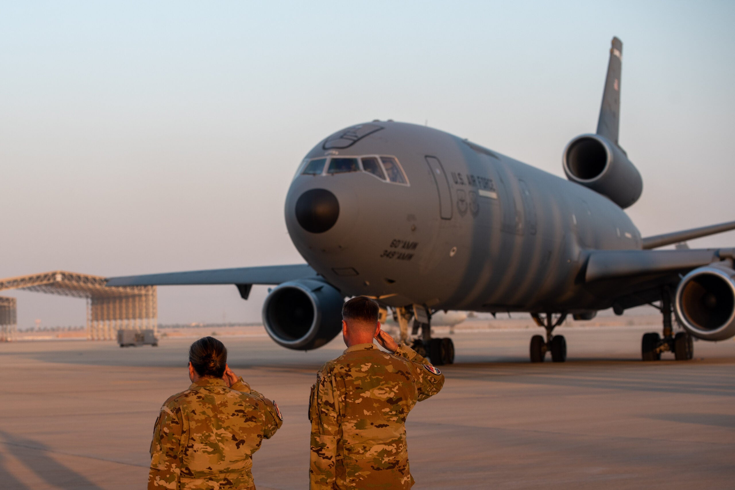 U.S. Airmen salute a KC-10 as it begins to depart after conducting the airframe's final combat deployment at Prince Sultan Air Base (PSAB), Kingdom of Saudi Arabia, Oct. 5, 2023. The departure of the KC-10 at PSAB marked the end of the airframe's over 30 years of service within the U.S. Air Forces Central (AFCENT) Area of Responsibility. By September 2024, the U.S. Air Force's fleet of KC-10s will be decommissioned and gradually replaced by the KC-46 aircraft. (U.S. Air Force photo by Tech. Sgt. Alexander Frank)