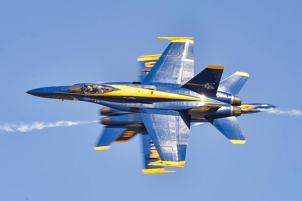 The U.S. Navy Flight Demonstration Squadron, the Blue Angels, solo pilots perform the knife-edge pass maneuver during the 2019 Lemoore Air Show.(U.S. Navy photo by Mass Communication Specialist 2nd Class Timothy Schumaker/Released)