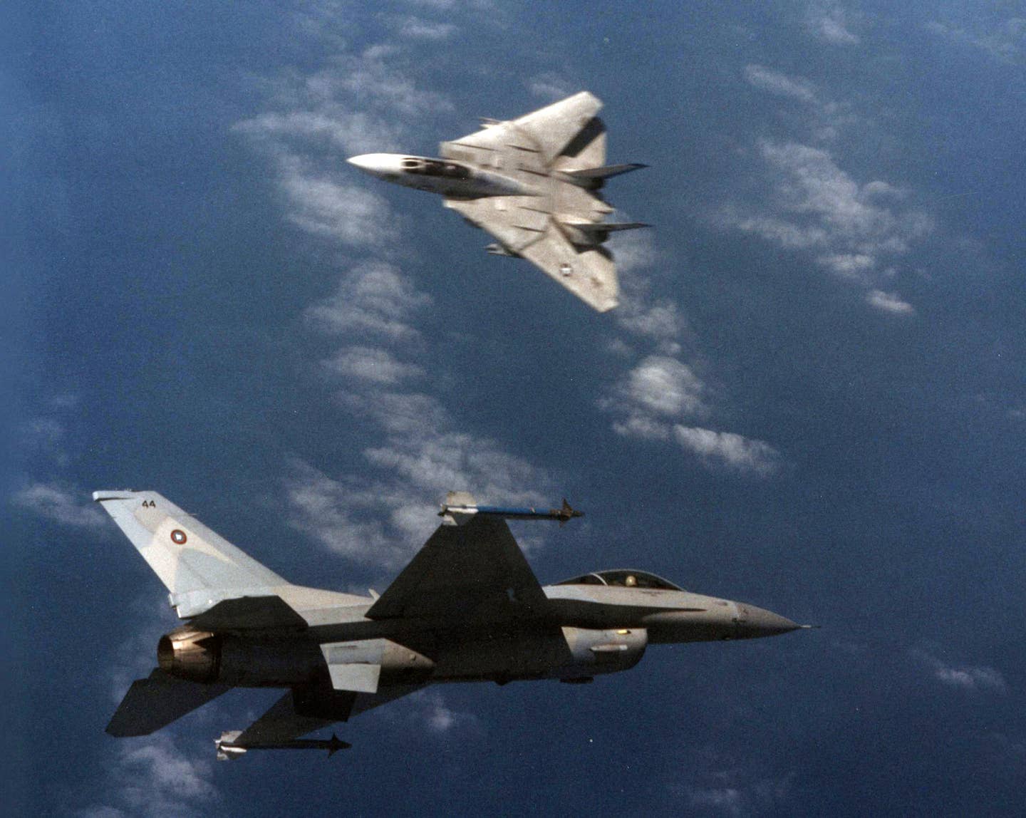 U.S. Navy Grumman F-14A Tomcat of Fighter Squadron 213 (VF-213) "Black Lions" engages a General Dynamics F-16N <em>Viper</em> aggressor aircraft during training at the Navy Fighter Weapons School (TOPGUN) at Naval Air Station Miramar, California, in March 1989.