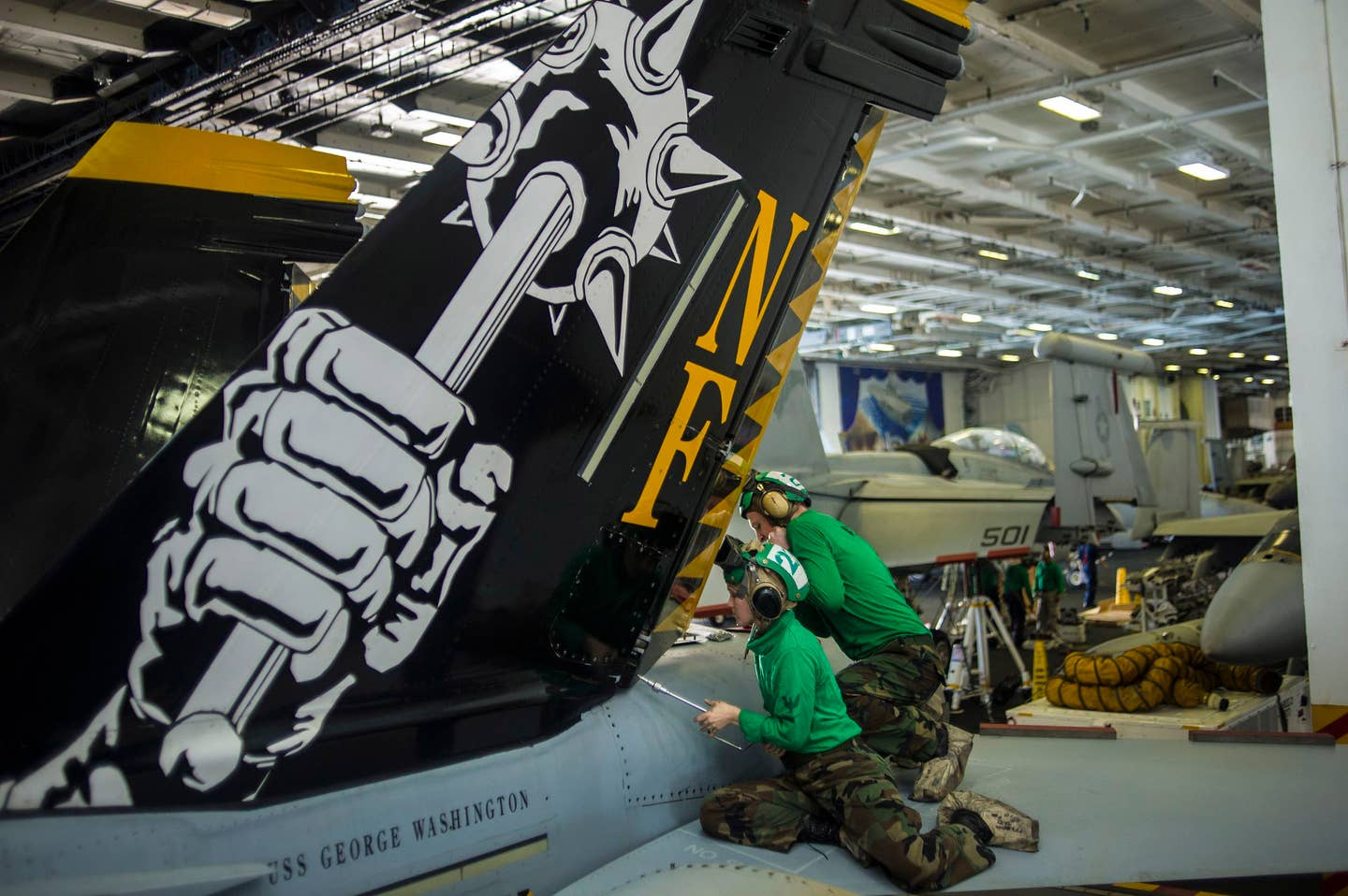 Sailors remove panels from an F/A-18E Super Hornet from the Royal Maces of Strike Fighter Squadron (VFA) 27 in the hangar bay of the aircraft carrier USS George Washington (CVN 73). (U.S. Navy photo by Mass Communication Specialist 3rd Class Ricardo R. Guzman/Released)