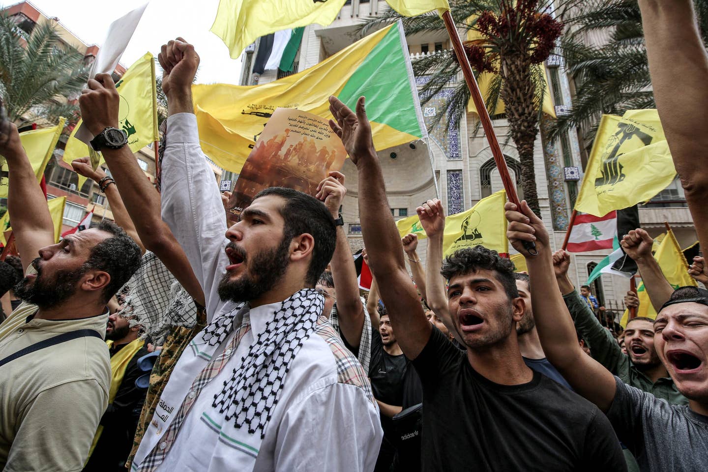 Lebanese pro-Iranian Hezbollah supporters take part in a rally in Beirut's southern suburbs to praise the unexpected attack by Hamas militants against Israeli towns and settlements near the Gaza Strip. (Photo by Marwan Naamani/picture alliance via Getty Images)