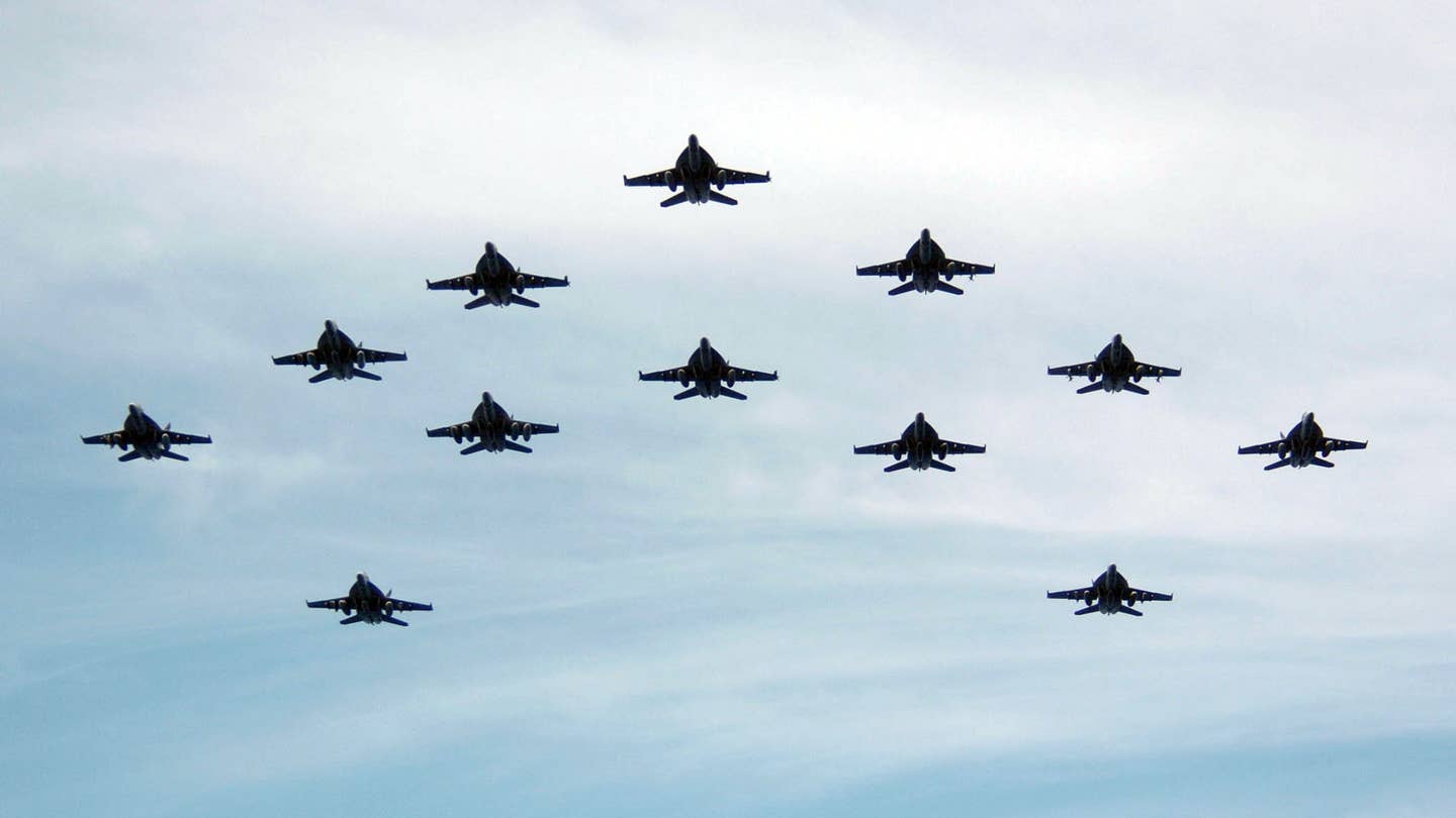 Twelve F/A-18F Super Hornet's, assigned to the "Diamondbacks" of Strike Fighter Squadron One Zero Two (VFA-102), perform a formation fly-by after completing their deployment aboard the conventionally powered aircraft carrier USS Kitty Hawk (CV 63). (U.S. Navy photo by Photographer's Mate 3rd Class Jonathan Chandler)