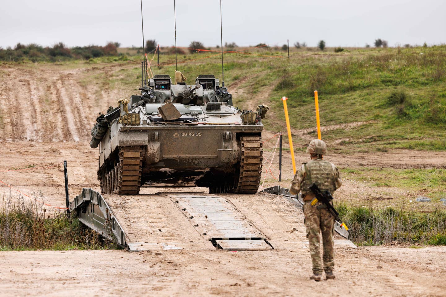 A Warrior IFV is guided over a small bridge during Exercise Iron Titan on Salisbury Plain. <em>Crown Copyright</em>