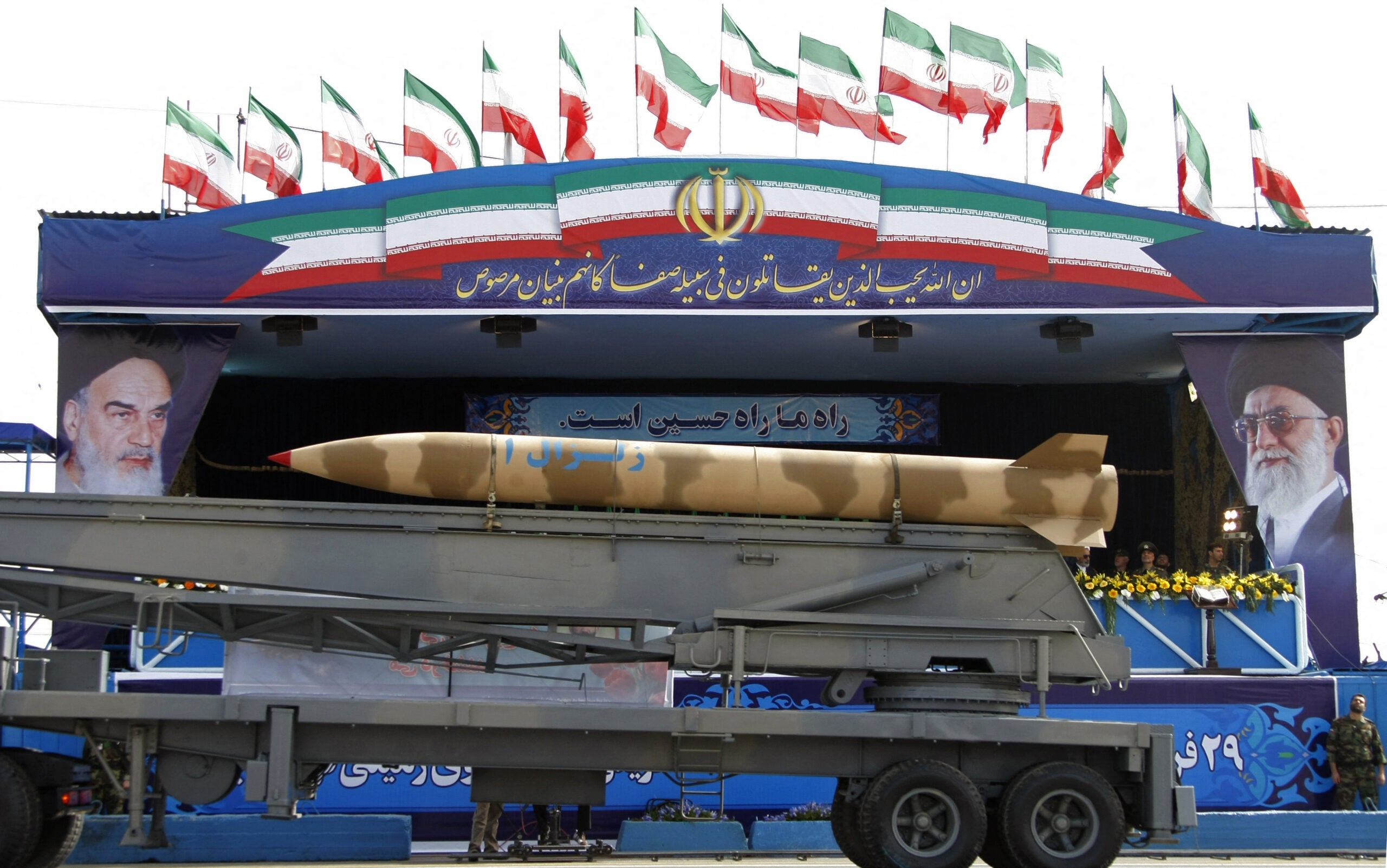 An Iranian surface-to-surface Zelzal-2 missile is driven past portraits of the Islamic republic's supreme leader, Ayatollah Ali khamenei (R), and his predecessor, the late Ayatollah Ruhollah Khomeini (L), during the Army Day parade in Tehran on April 18, 2009. Iranian President Mahmoud Ahmadinejad hailed his country's armed forces as the "guarantor" of regional security, during the low-profile parade in the capital. AFP PHOTO/BEHROUZ MEHRI (Photo by Behrouz MEHRI / AFP) (Photo by BEHROUZ MEHRI/AFP via Getty Images)