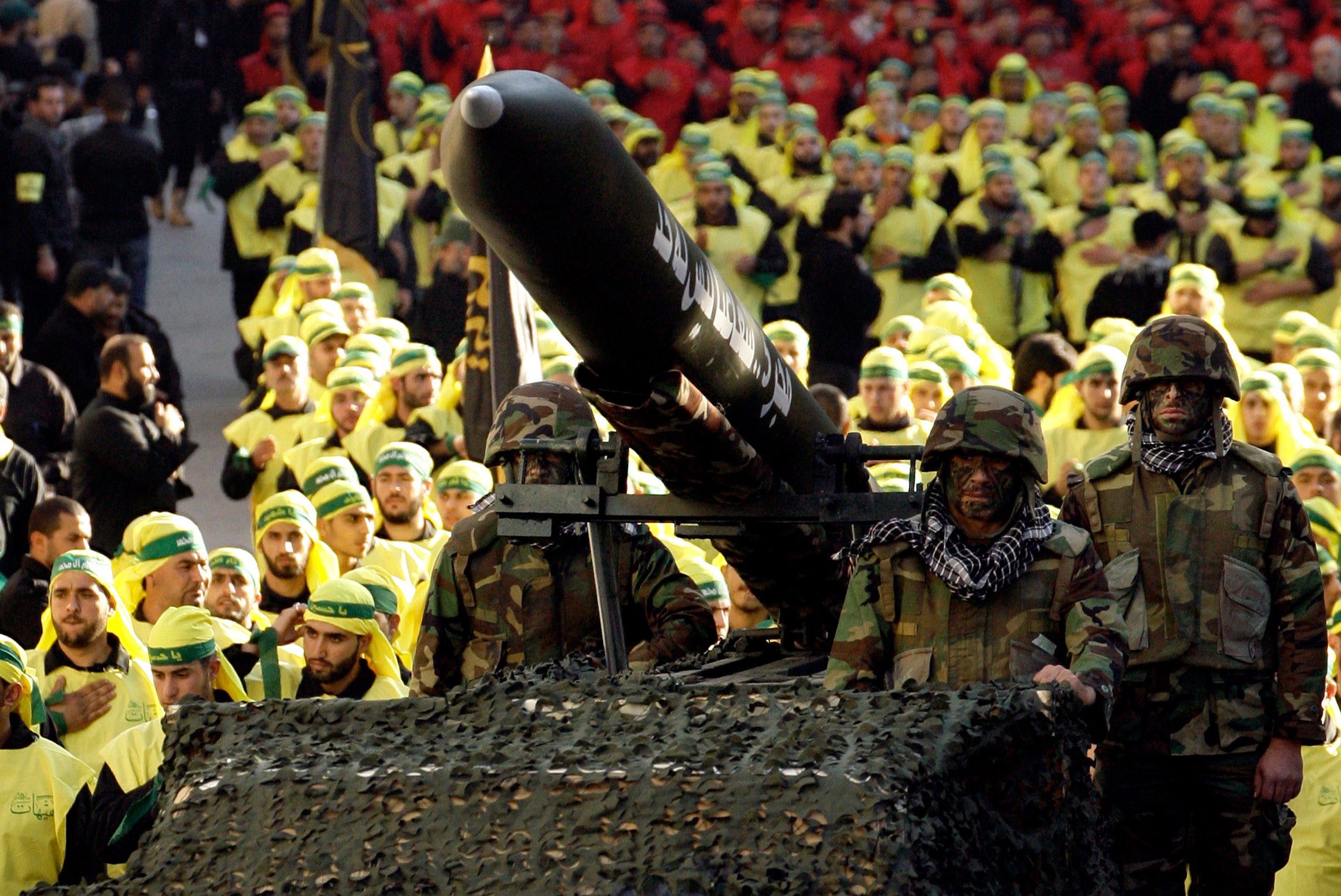 Lebanese Shiite Muslim Hezbollah militants ride on a vehicle carrying a Fajr 5 missile during the annual parade in the southern town of Nabatiyeh on November 28, 2012, to mark the 13th day of Muharram on the Islamic calendar, commemorating and mourning the seventh-century martyrdom of Prophet Muhammad's grandson, Imam Hussein, in the battle of Karbala in Iraq. AFP PHOTO/MAHMOUD ZAYYAT        (Photo credit should read MAHMOUD ZAYYAT/AFP via Getty Images)