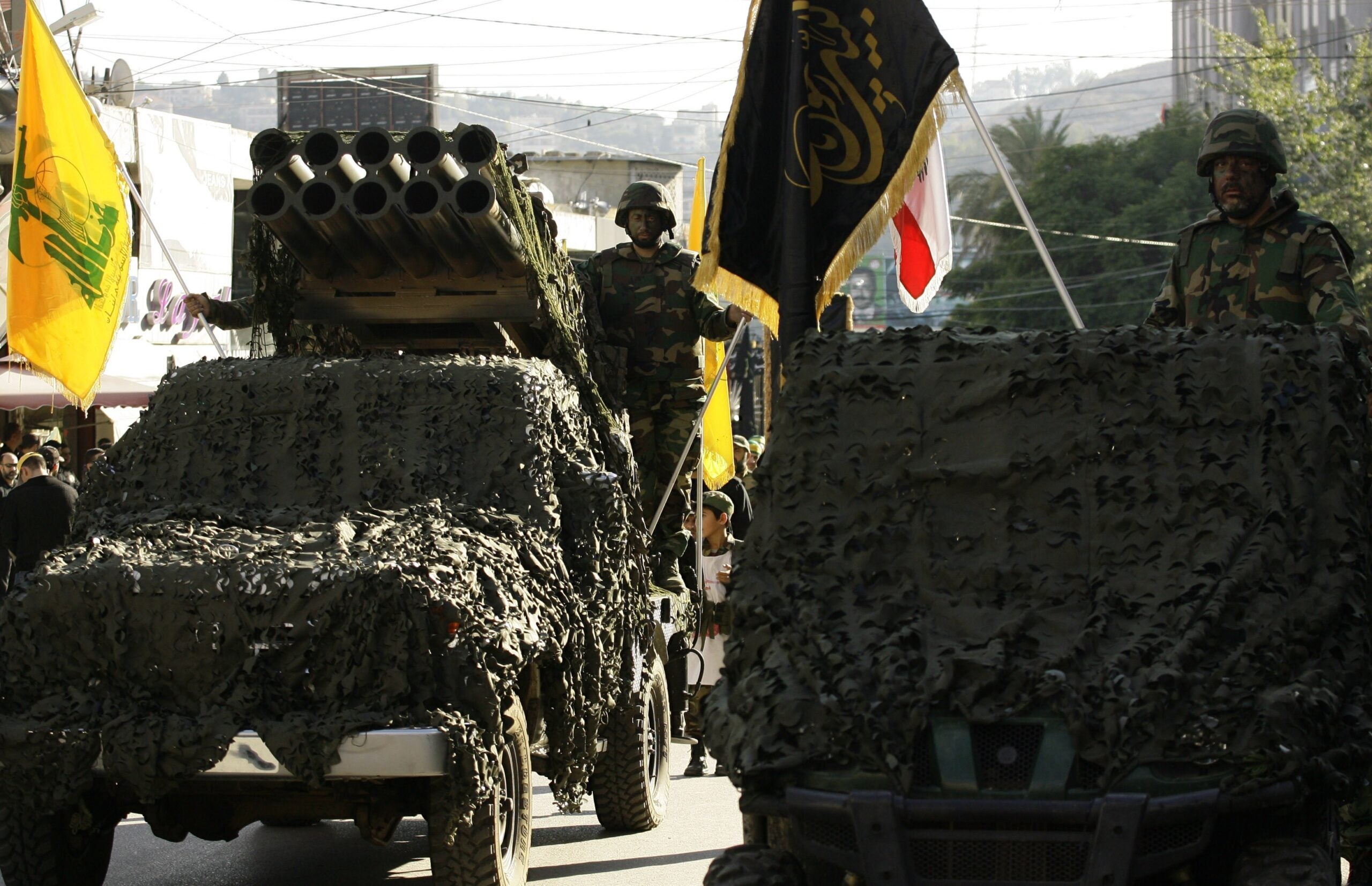 Members of Lebanon's militant Shiite Muslim movement Hezbollah stand on a pick-up truck mounted with a multiple rocket launcher as they take part in a parade in the southern city of Nabatiyeh on November 7, 2014, to mark the 13th day of Ashura, where believers mourn the killing of the Prophet Mohammed's grandson, Imam Hussein, during the battle of Karbala in central Iraq in the seventh century. AFP PHOTO / MAHMOUD ZAYYAT        (Photo credit should read MAHMOUD ZAYYAT/AFP via Getty Images)