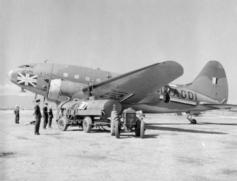 The BOAC-operated Curtiss CW-20A (the prototype of the C-46), G-AGDI, named <em>St. Louis</em>, is refueled at Gibraltar, in 1941 or 1942. <em>Crown Copyright</em>