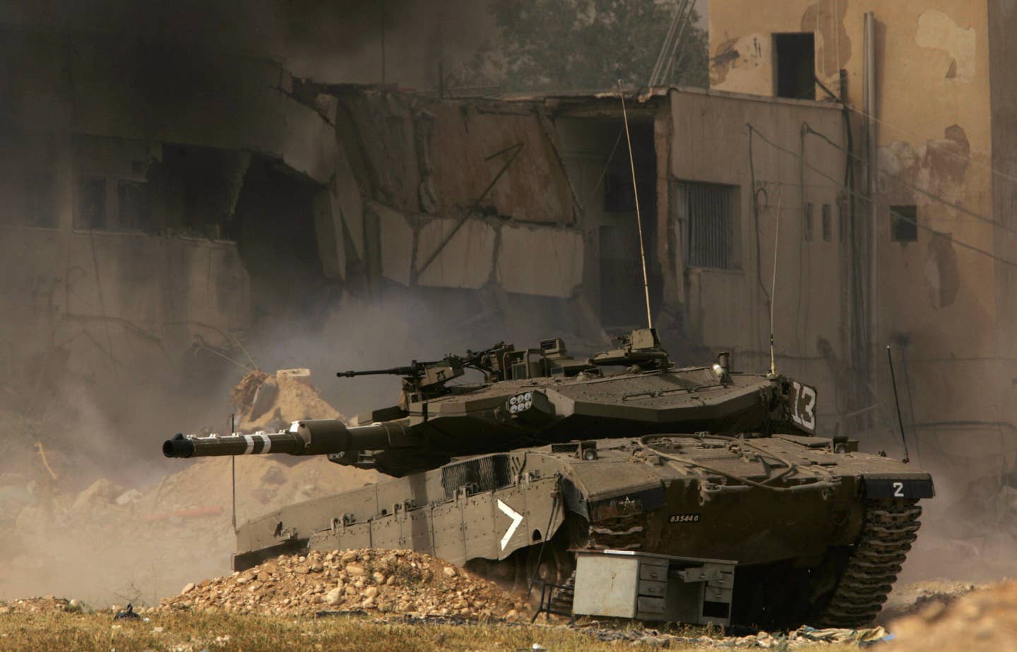 Israeli tank rolls into position as the Palestinian jail compound is stormed by Israeli troops in the West Bank town of Jericho, March 14, 2006. (Photo credit should read SAMUEL ARANDA/AFP via Getty Images)