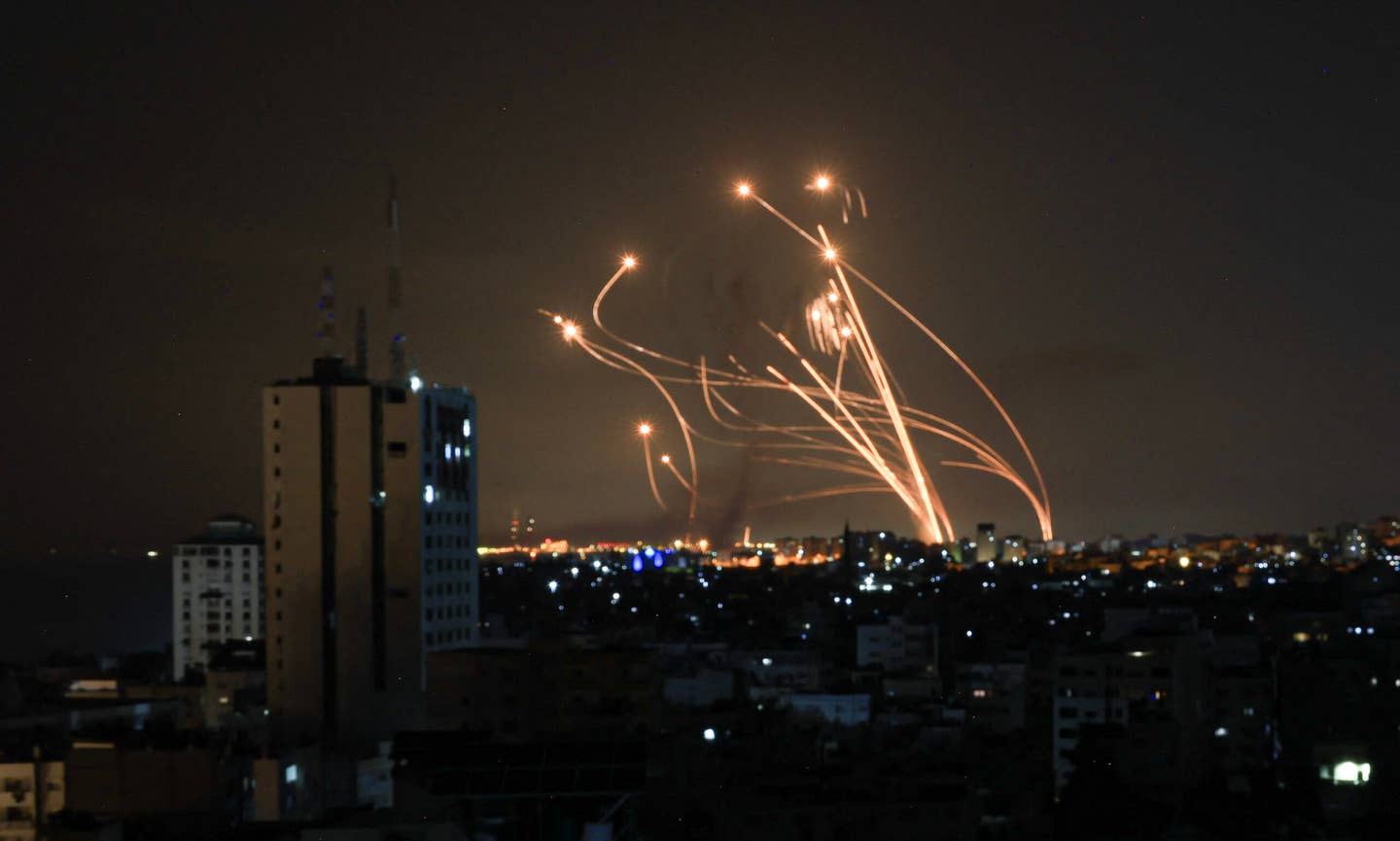 Missiles launched from the Iron Dome missile system intercept rockets fired from the Gaza Strip, over the city of Netivot in southern Israel, on October 8, 2023. <em>Photo by MAHMUD HAMS/AFP via Getty Images</em>