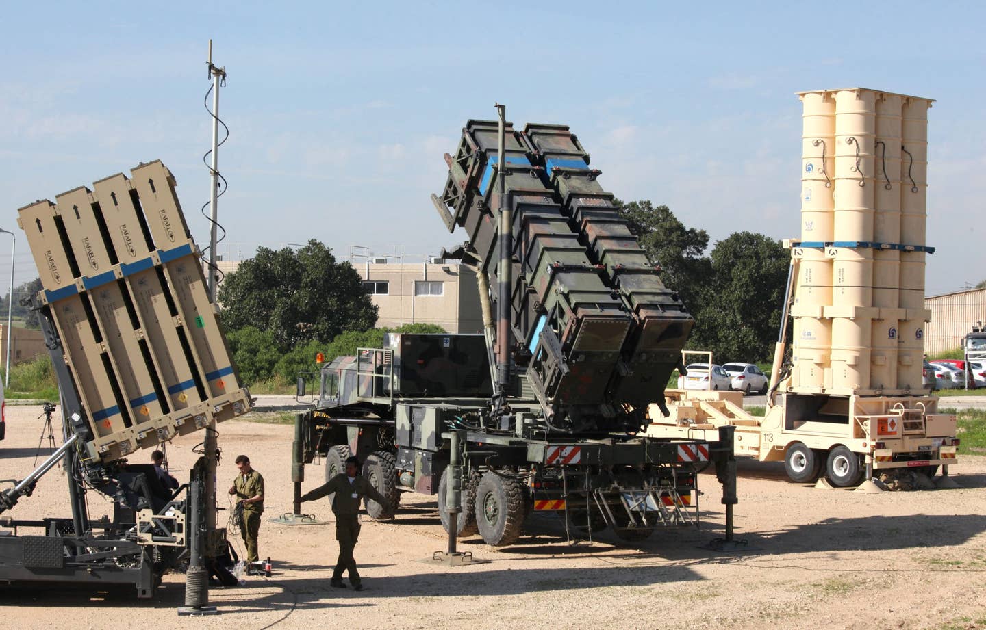 An Israeli Iron Dome air defense system (left), a MIM-104 Patriot (center), and an Arrow 3 anti-ballistic missile system (right) during the U.S.-Israeli Exercise Juniper Cobra at Hatzor Israeli Air Base in central Israel, on February 25, 2016. <em>Photo by GIL COHEN-MAGEN/AFP via Getty Images</em>