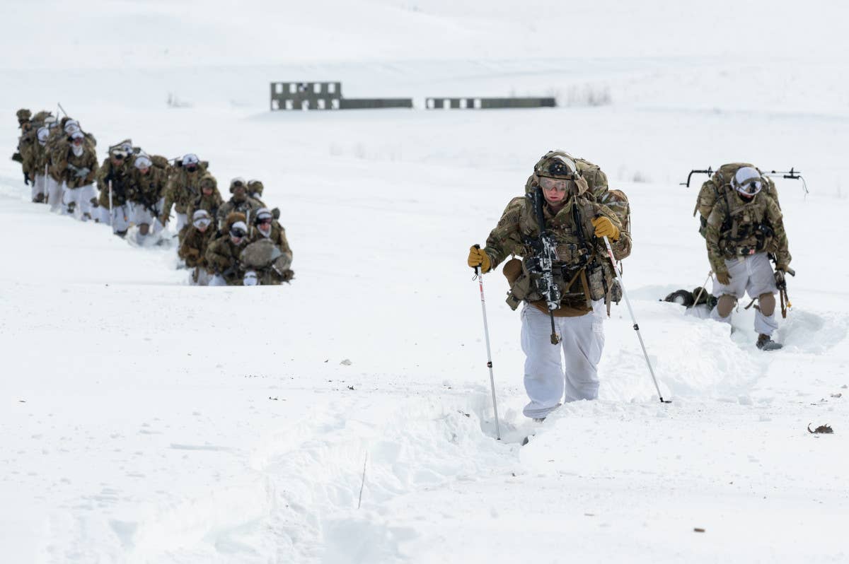 Members of the 11th Airborne Division plod through the snow. <em>US Army</em>