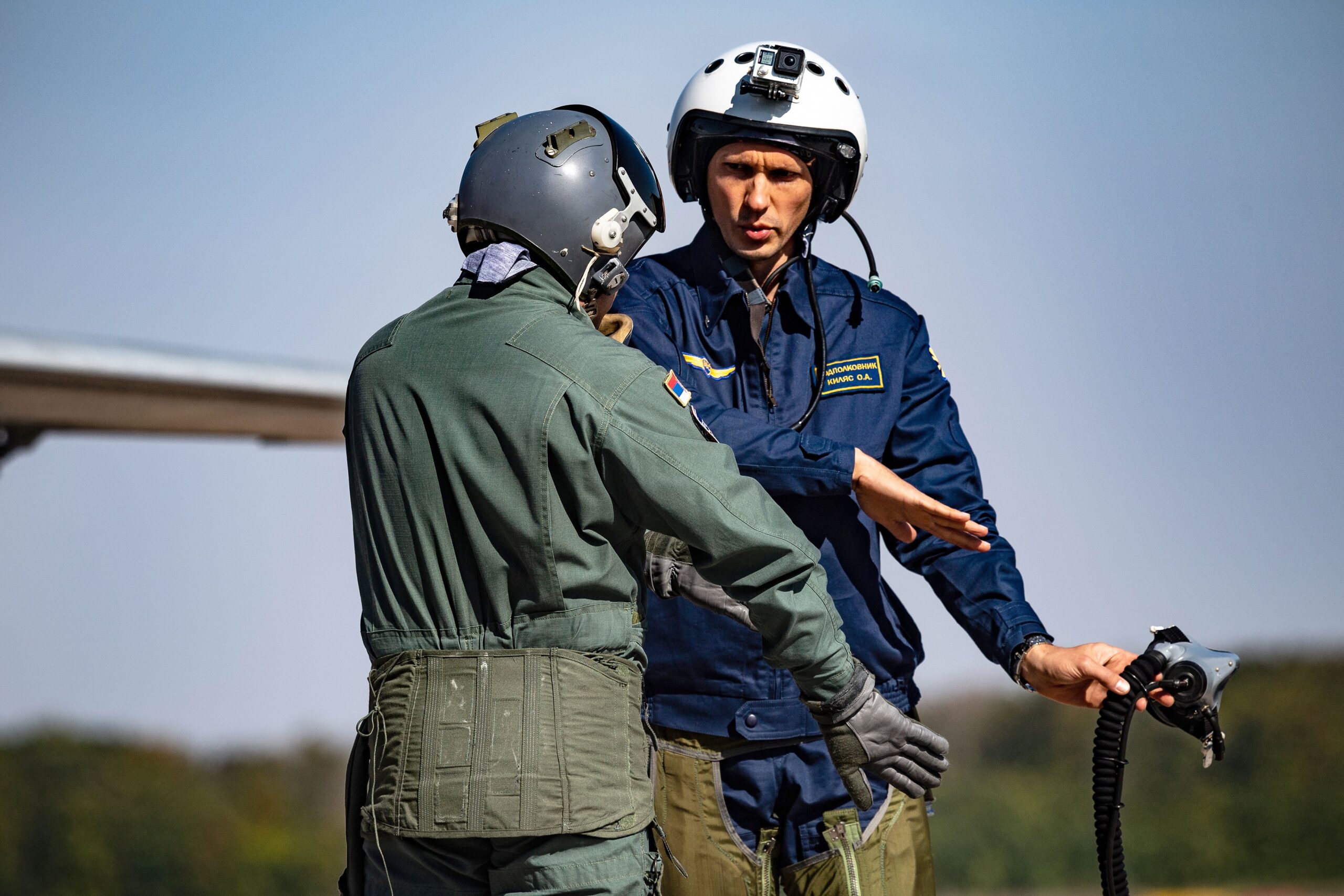 Russian (right) and Serbian pilots discuss tactics before boarding a Serbian Air Force MiG-29 fighter at Batajnica on October 4, 2018. <em>ANDREJ ISAKOVIC/AFP via Getty Images</em>
