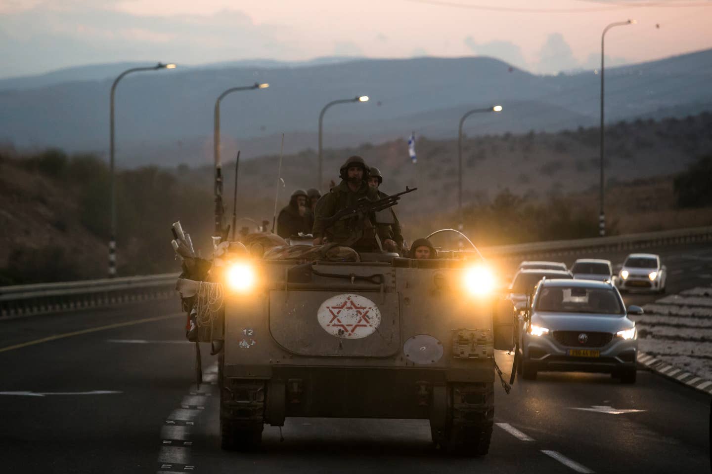 Israeli M113-series medical armored personnel carriers move along the highway in Amiad, Israel, near the border with Lebanon, on October 15, 2023. <em>Footage by Amir Levy/Getty Images</em>