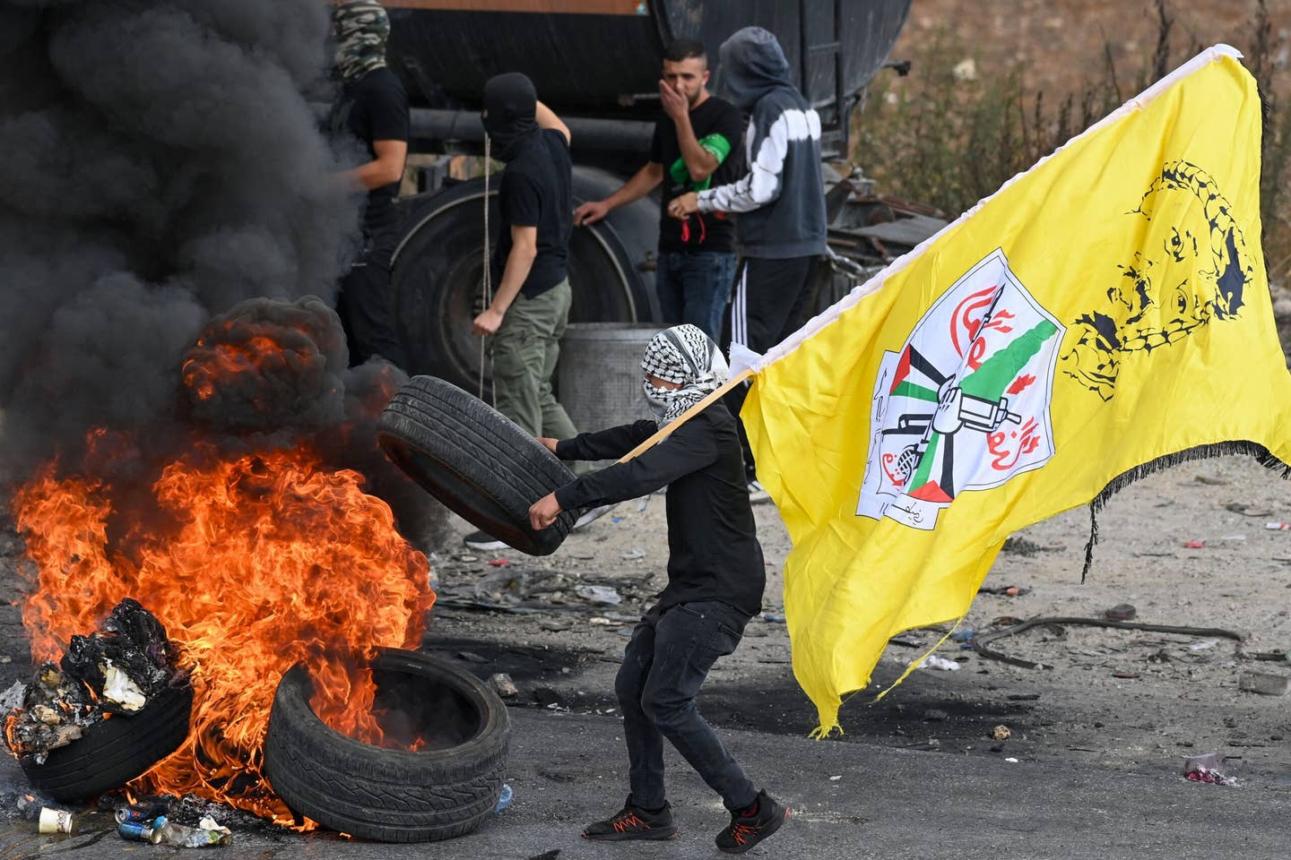 Palestinian youths burn tyres during clashes with Israeli security forces in the occupied West Bank city of Ramallah on October 20, 2023, amid ongoing battles between Israel and Hamas militants. (Photo by YURI CORTEZ / AFP) (Photo by YURI CORTEZ/AFP via Getty Images)