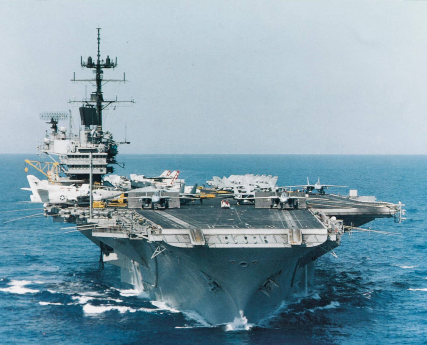 USS <em>Saratoga</em> (CV-60) underway with three F-14 fighters on her bow and waist catapults during operations in the Mediterranean Sea, September 16, 1985. <em>Naval History and Heritage Command</em>