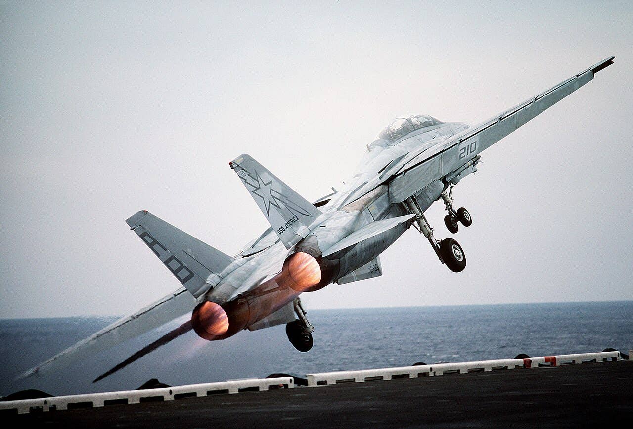 A U.S. Navy Grumman F-14A Tomcat of Fighter Squadron 33 (VF-33) "Starfighters" launched off the deck back in 1987. <em>U.S. Navy</em>