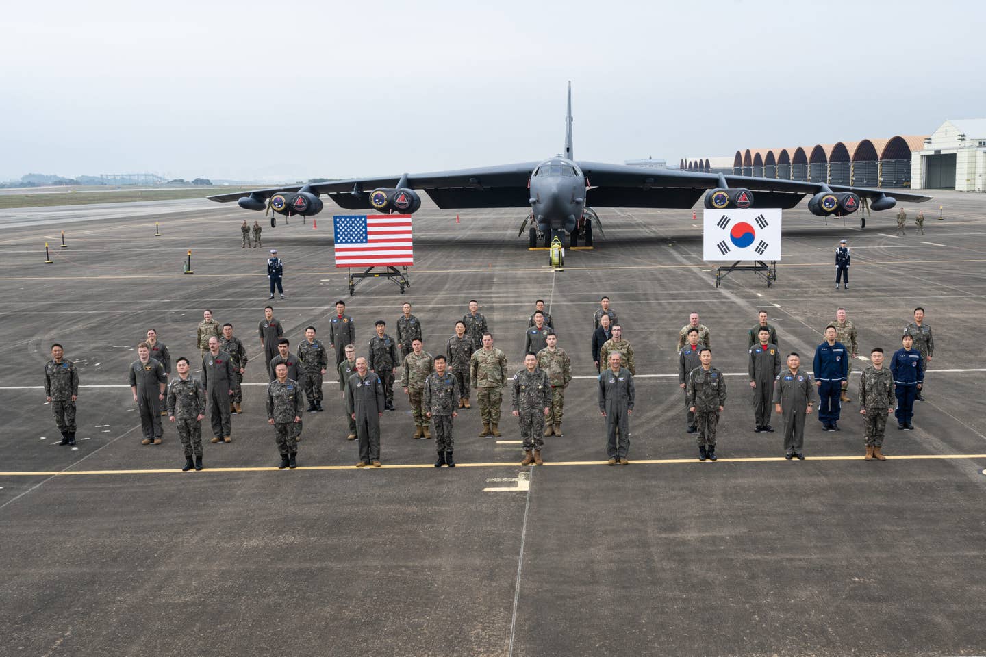 Service members from the U.S. Air Force and the Republic of Korea Air Force pose for a group photo in front of a B-52H Stratofortress from the 96th Bomb Squadron at Barksdale Air Force Base, Louisiana in the Republic of Korea, October 19, 2023. The U.S. B-52 deployed to the Korean peninsula to participate in the 2023 Seoul International Aerospace and Defense Exhibition, scheduled for Oct. 17-22, in celebration of the Republic of Korea and the U.S. Alliance’s 70th Anniversary. Support to airshows and other regional events allows the U.S. to demonstrate its commitment to the stability and security of the Indo-Pacific region, promote standardization and interoperability of equipment, and display capabilities critical to the success of military operations. (U.S. Air Force photo by Airman 1st Class Nicole Ledbetter)