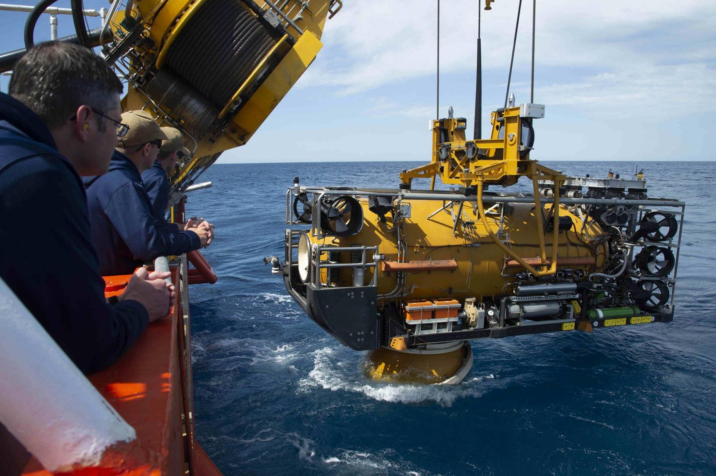 Sailors assigned to the Navy’s Undersea Rescue Command observe as the U.S. Navy Pressurized Rescue Module (PRM) system deploys from the Royal Malaysian Submarine Rescue Ship, MV <em>Mega Bakti</em>, during Exercise Pacific Reach (PACREACH) in 2019. <em>U.S. Navy/Thomas Gooley</em>