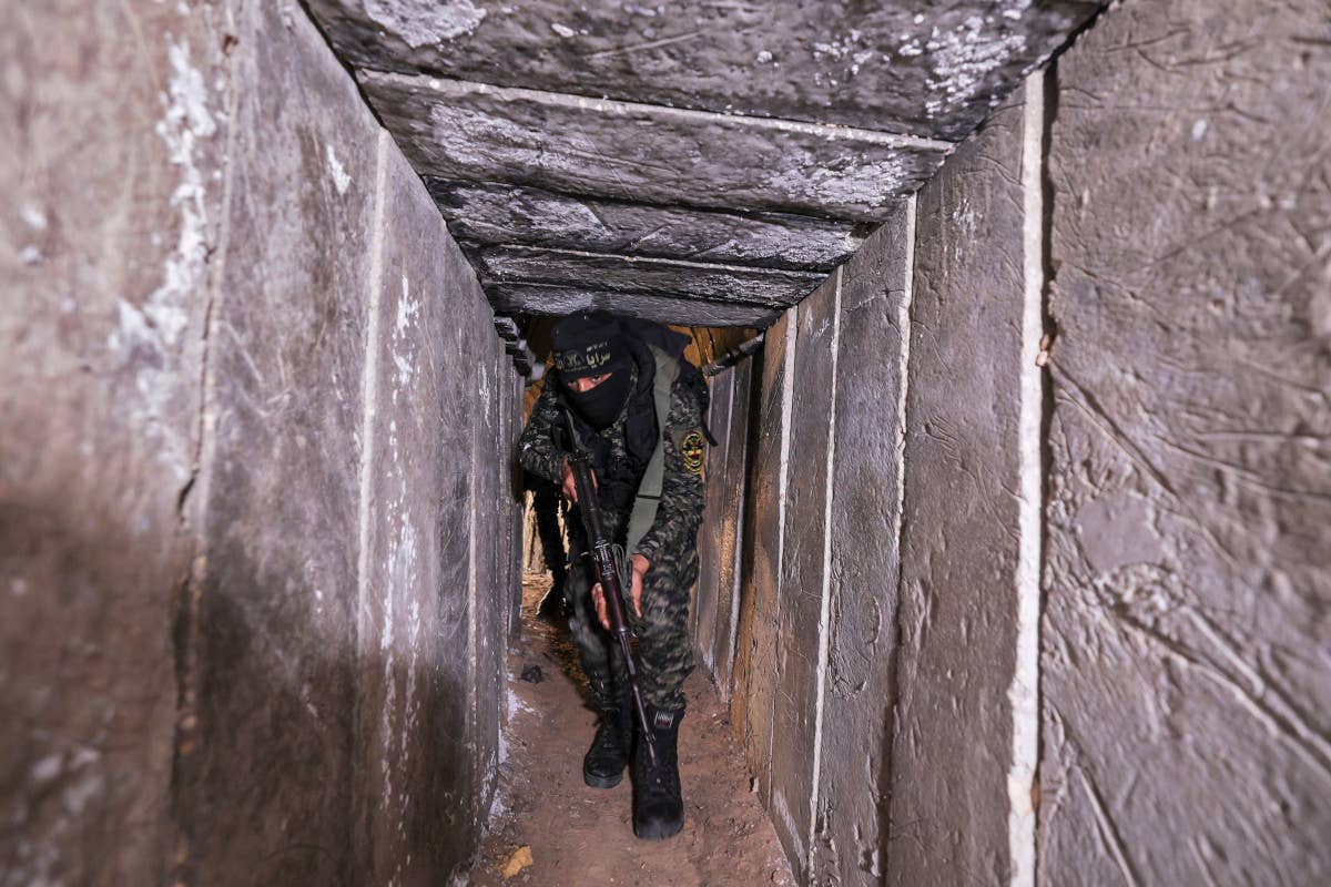 A member of the terrorist group Palestinian Islamic Jihad moves through a tunnel in the Gaza Strip in 2022. <em>MAHMUD HAMS/AFP via Getty Images</em>