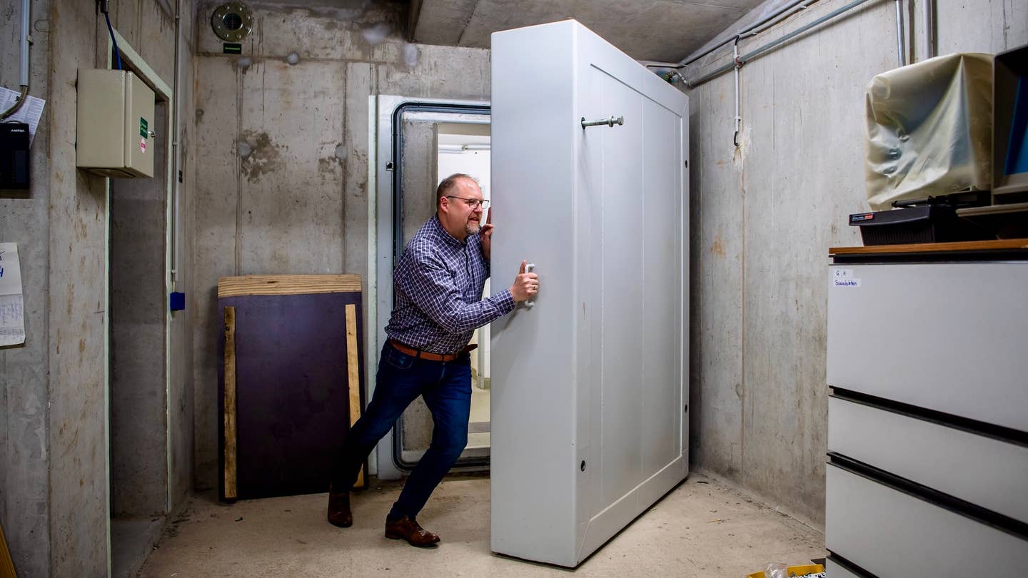 Thomas Otto (non-party), mayor of the municipality of Saterland, pries open a heavy door to the deconsecrated shelters in the basement of the town hall