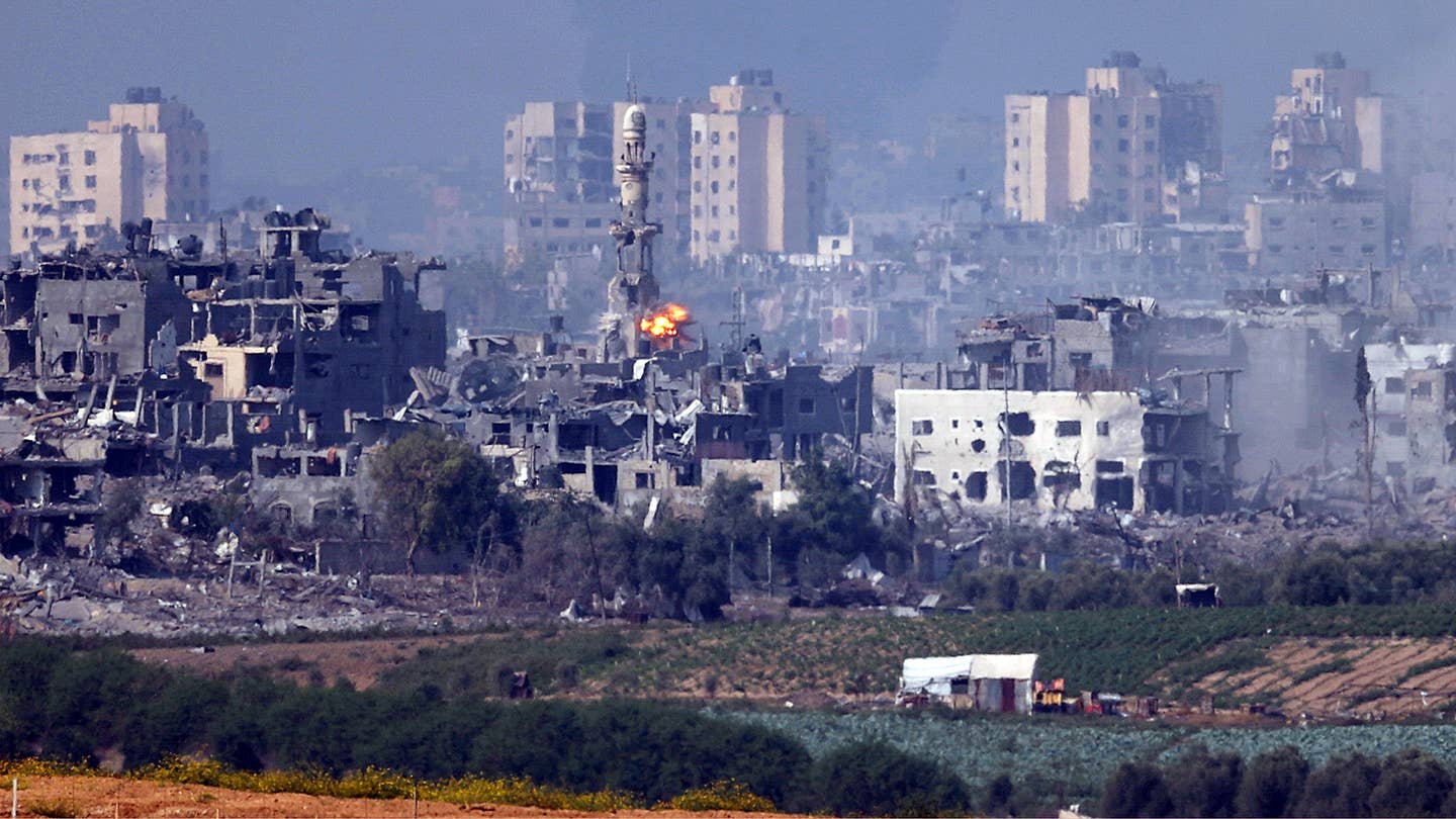 A missile strikes behind a minaret in Gaza on October 28, 2023 seen from Sderot, Israel.