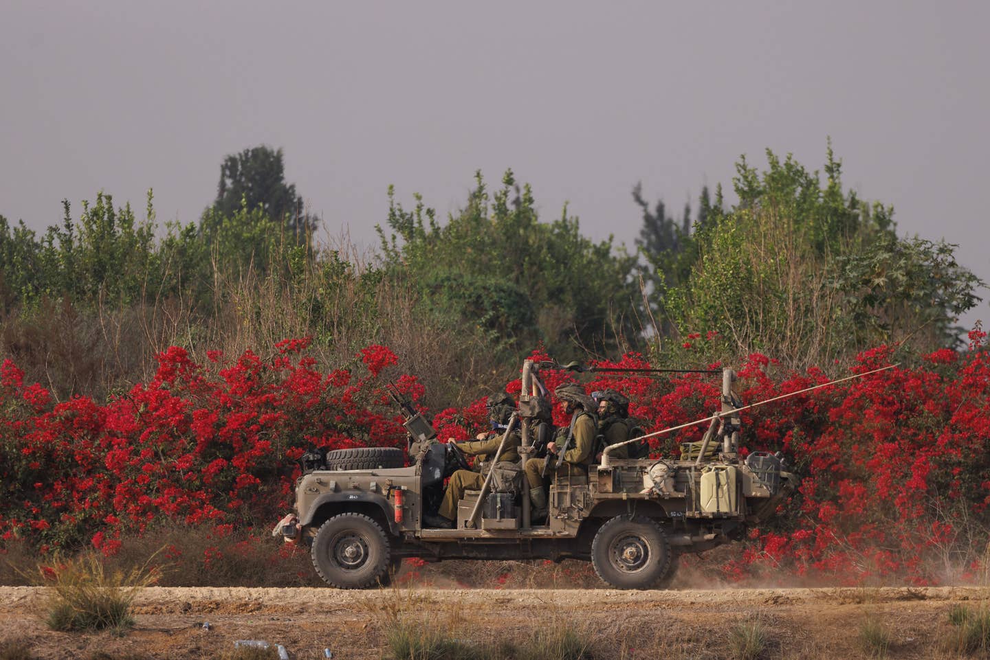 Israeli troops in a machine-gun-armed Land Rover move near the border with Gaza on October 28, 2023, in Sderot, Israel. <em>Photo by Dan Kitwood/Getty Images</em>