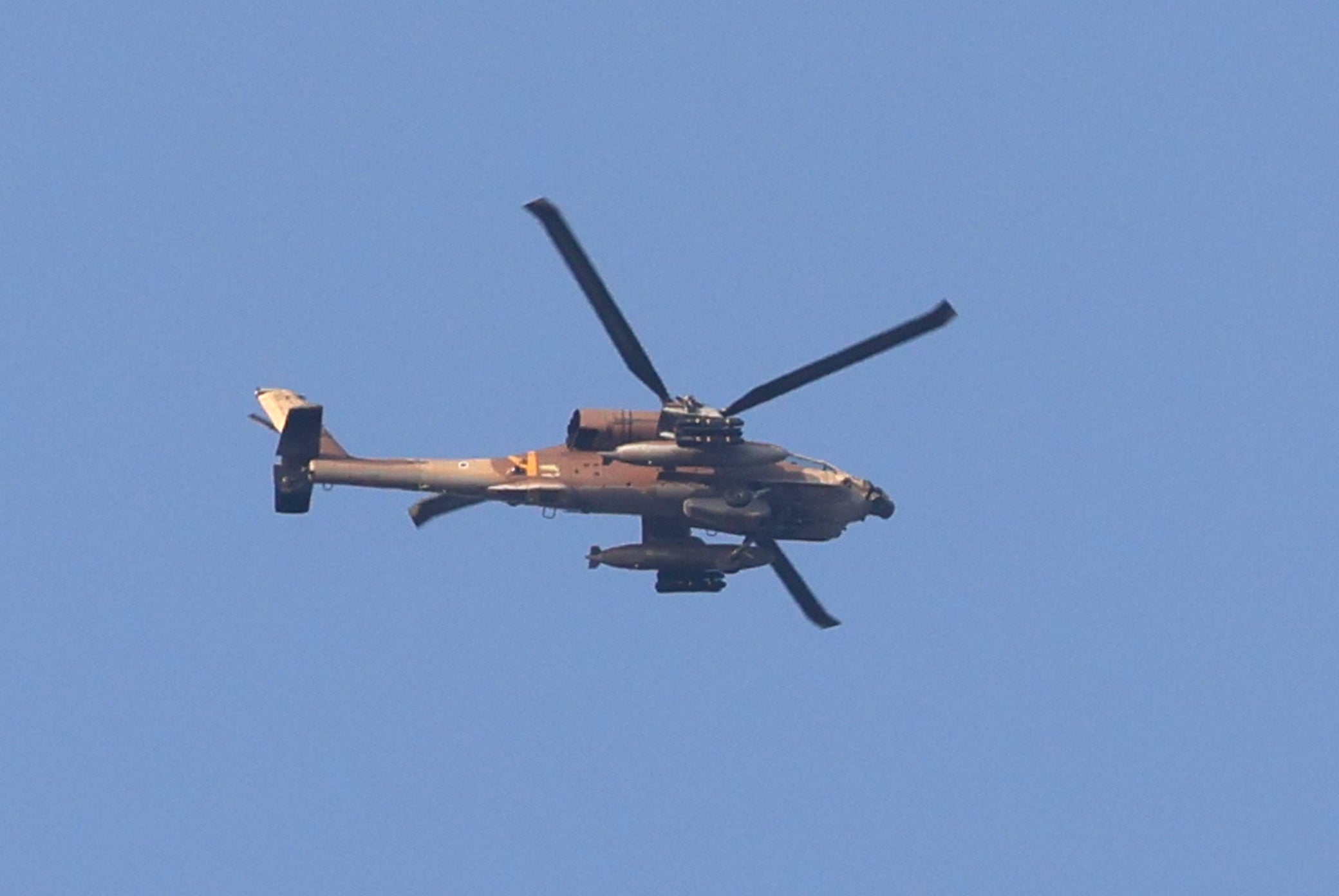An Israeli Apache helicopter is pictured over the Israel's southern city of Ashkelon during an Israeli air strike on Gaza City, on August 5, 2022. - A senior militant from Islamic Jihad was killed in an Israeli air strike on the Gaza Strip today, prompting the militant group to warn Israel has "started a war".
A child was among those killed in the strikes, the enclave's health ministry said, while Israel's military estimated 15 were dead. (Photo by JACK GUEZ / AFP) (Photo by JACK GUEZ/AFP via Getty Images)