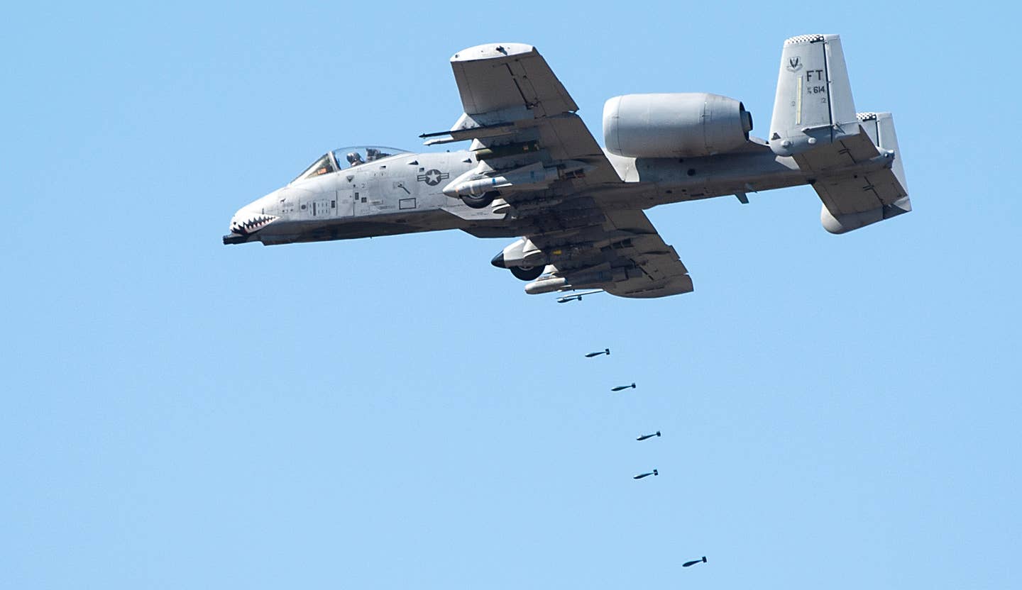 What type of inert muntions were utilized during flyoff is unknown. The picture here shows an A-10 dropping a string of small inert training bombs during unrelated training. <em>USAF</em>