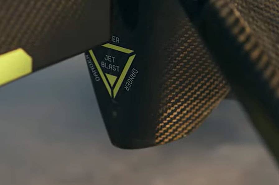 A close up of the base of a Roadrunner from Anduril's promotional video showing a jet blast warning marking. <em>Anduril capture</em>