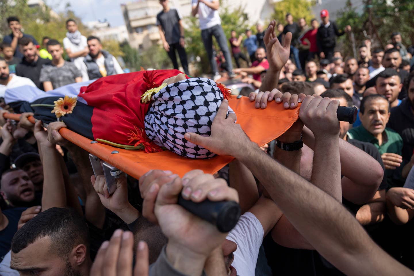Mourners carry the body of Ayham Shafe'e, 14, during his funeral in the West Bank city of Ramallah, Thursday, Nov. 2, 2023. Shafee and a second Palestinian man were killed during an Israeli army raid in Ramallah early morning, the Palestinian Health Ministry said.(AP Photo/Nasser Nasser)