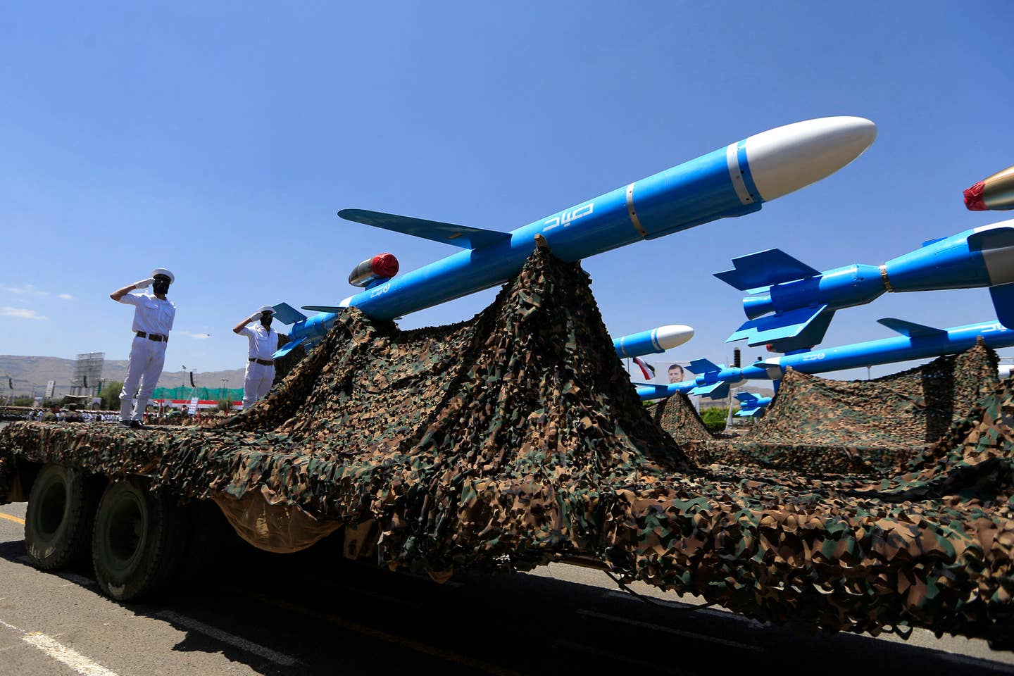 Soldiers stand guard on a Quds-type cruise missile during an official military parade marking the ninth anniversary of the Houthi takeover of the Yemeni capital, Sanaa, on September 21, 2023. <em>Photo by MOHAMMED HUWAIS/AFP via Getty Images</em>