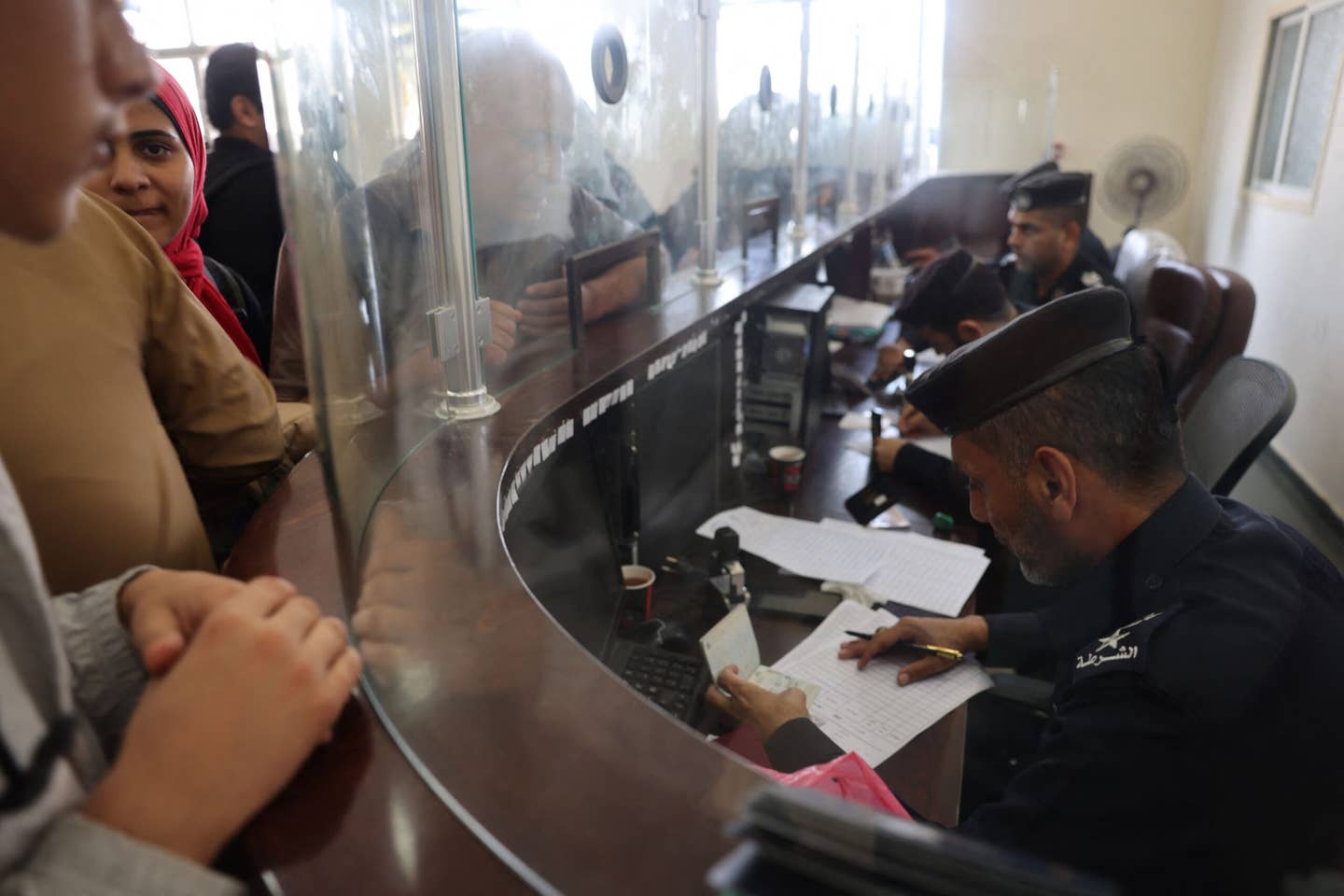 Civilians leaving the Gaza, have their papers checked as dual national Palestinians and foreigners prepare to cross the southern Rafah border point with Egypt, in the southern Gaza Strip, on November 3, 2023. (Photo by Mohammed ABED / AFP) (Photo by MOHAMMED ABED/AFP via Getty Images)
