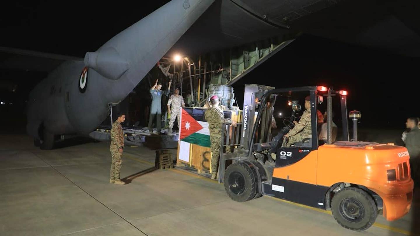 Jordanian personnel load aid bound for the country's field hospital in Gaza onto a C-130 Hercules cargo plane. <em>Jordanian Armed Forces</em>